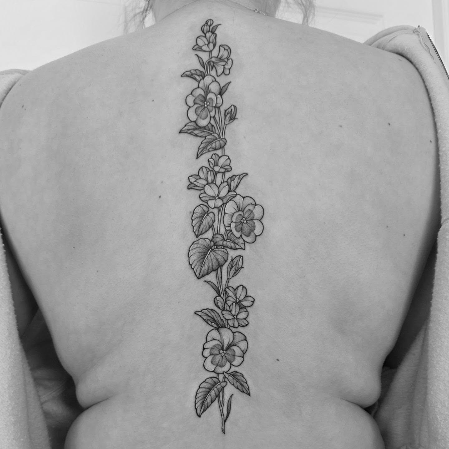 Flower vine black and grey tattoo on the back by Dani Bond