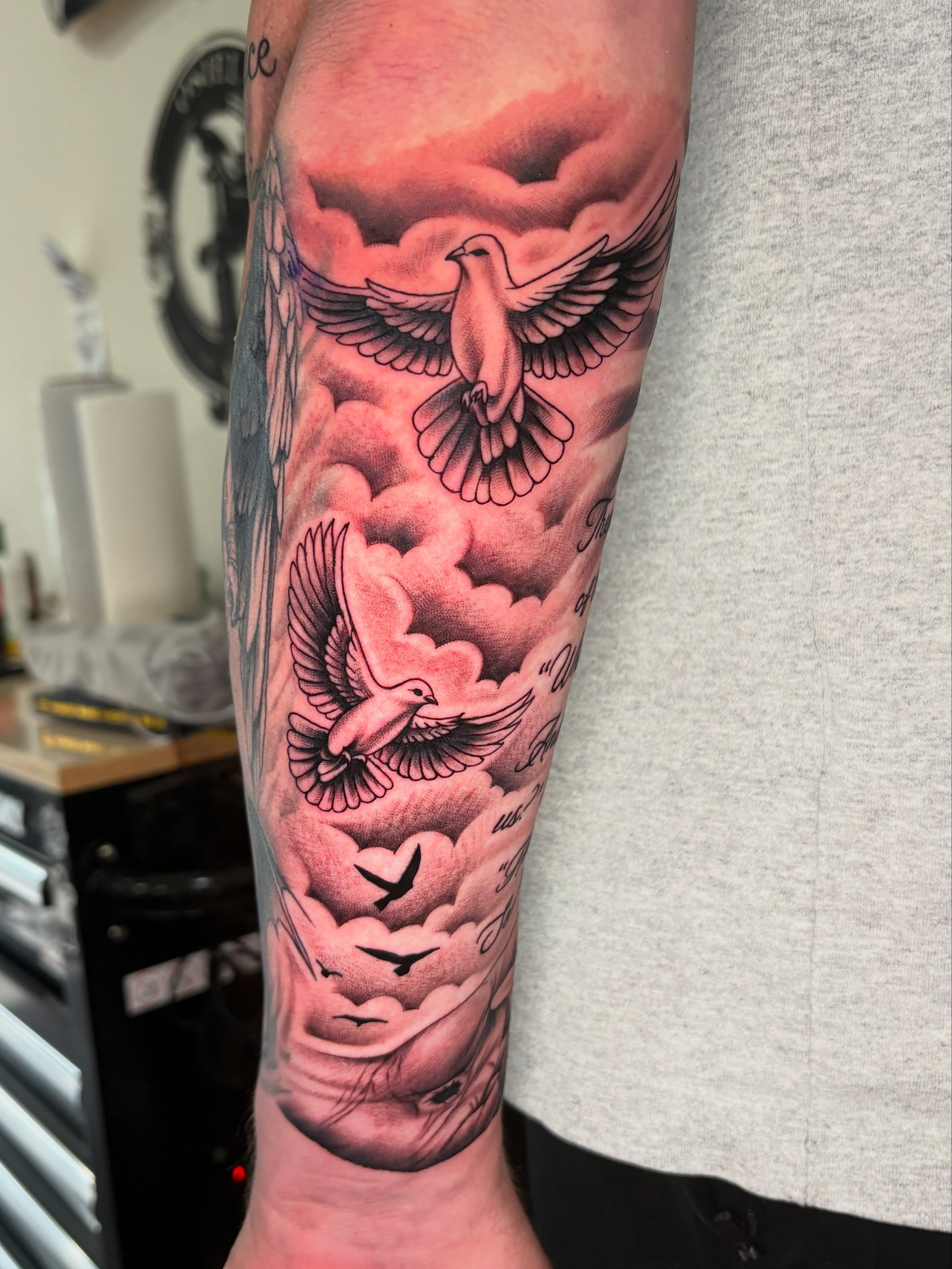 Doves and clouds realism tattoo on the forearm by Osiel Rodriguez