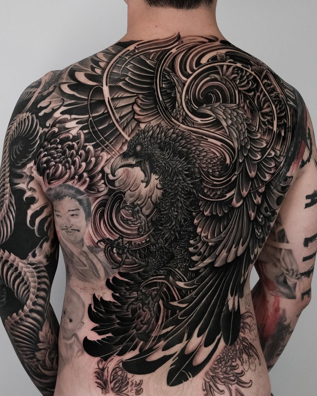 Eagle and chrysanthemum Japanese tattoo on the back by Yujin Ju