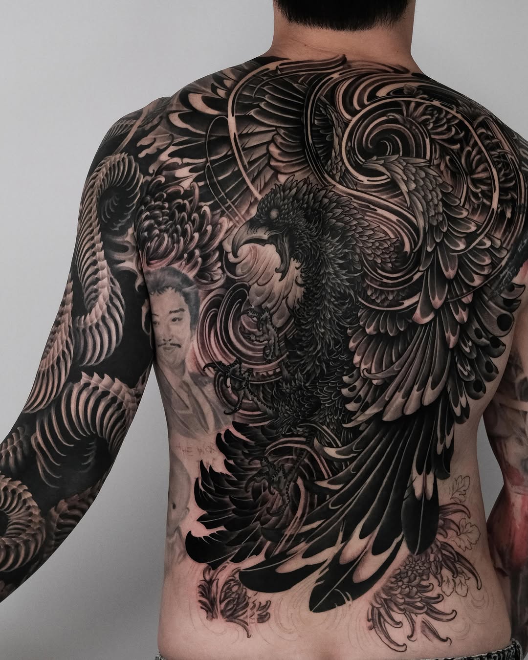 Phoenix and chrysanthemum Japanese tattoo on the back by Yujin Ju