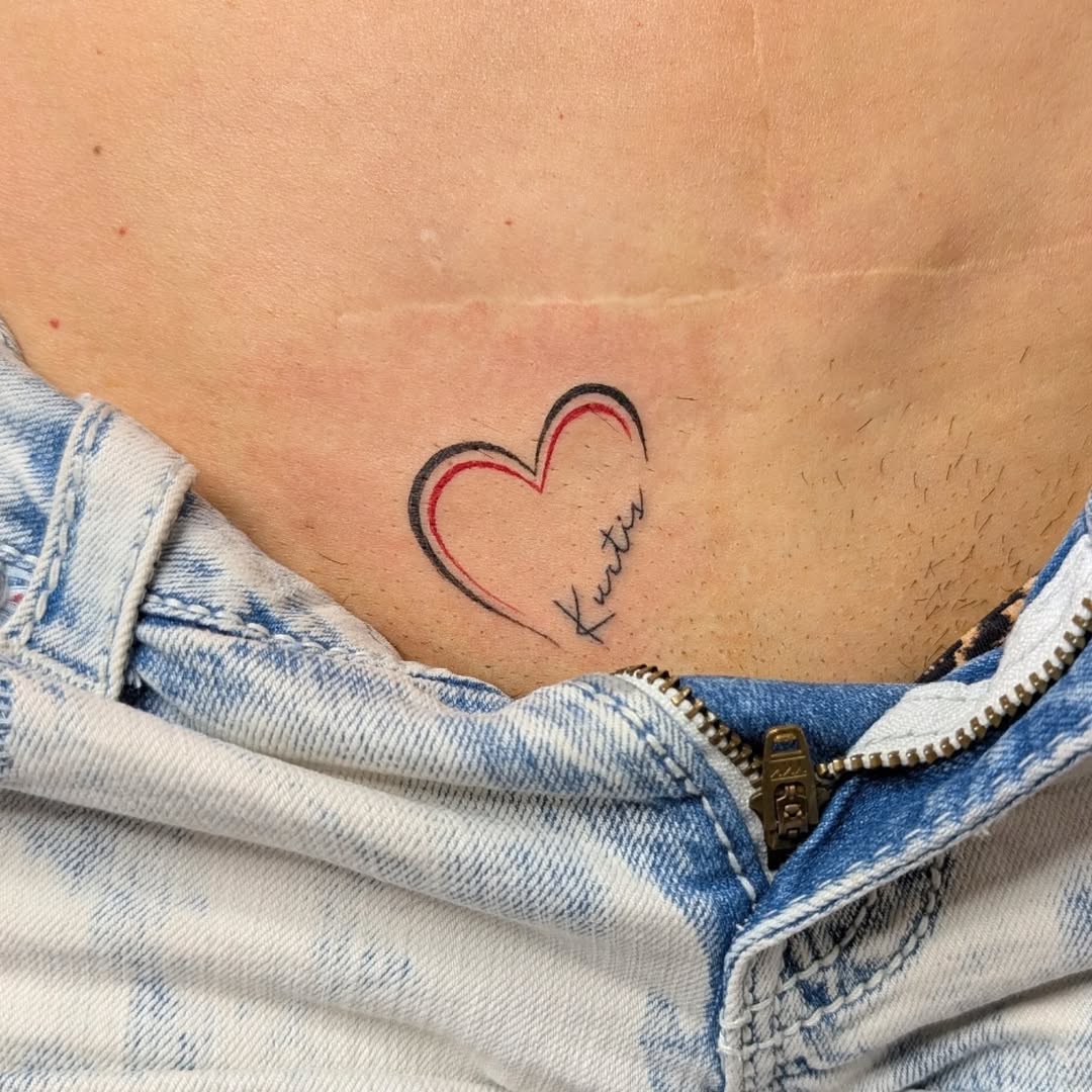 Heart with name lettering tattoo on the torso by Nenookaasi Martin