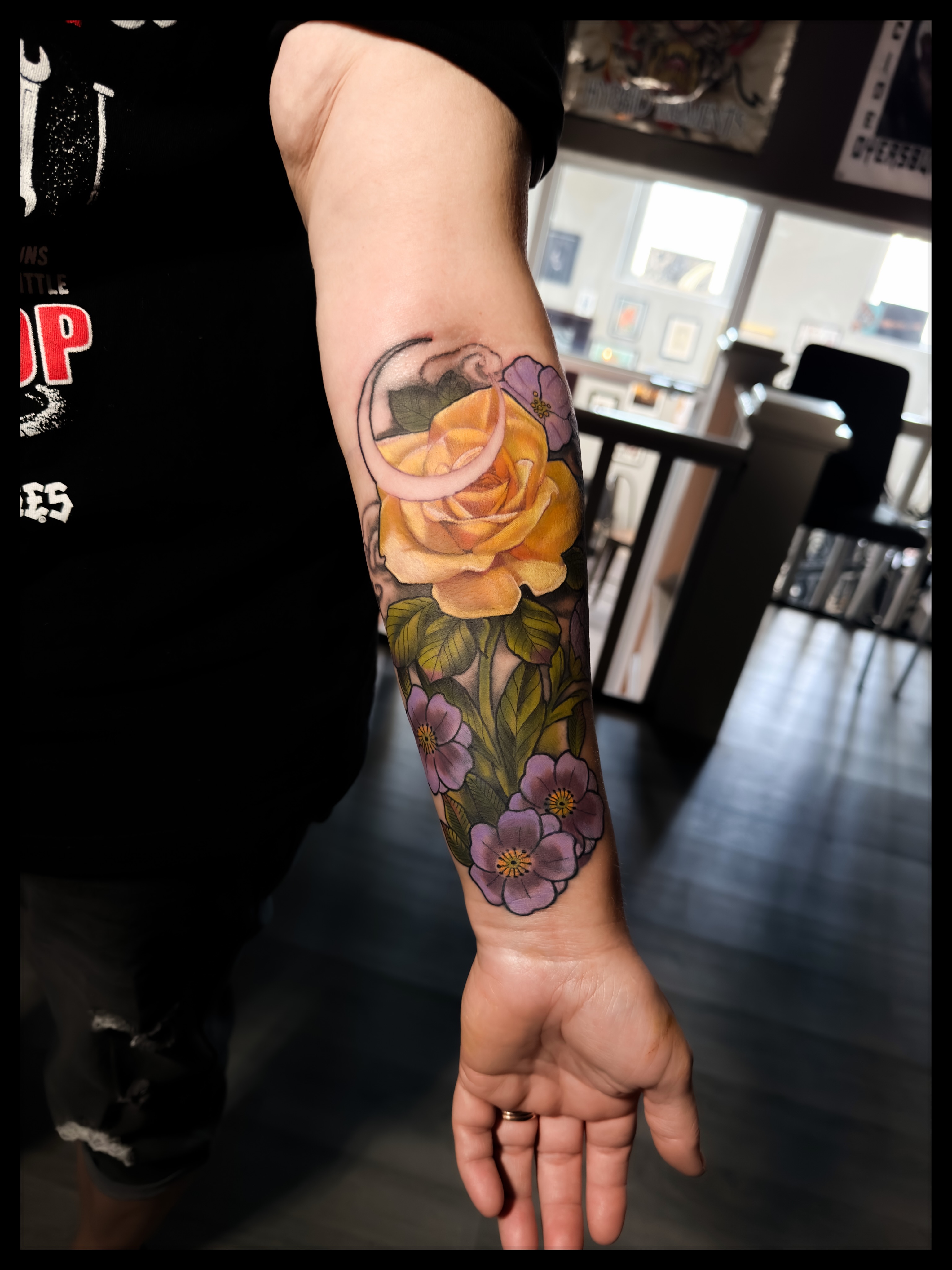 Floral bouquet realism tattoo on the forearm by Noah Morris