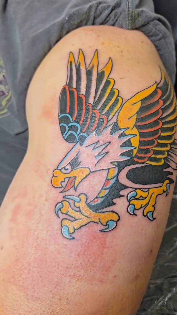 Eagle tattoo American traditional tattoo on the upper arm by Captain Michael Devious