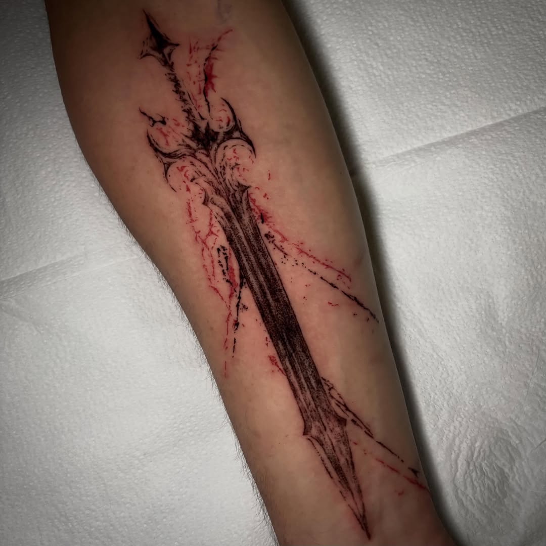 Sword black and grey tattoo on the forearm by unknown liquids tattoo