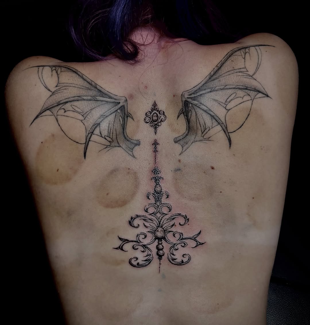 Bat wings and ornamental design cyber sigilism tattoo on the back by Cullen-Lee