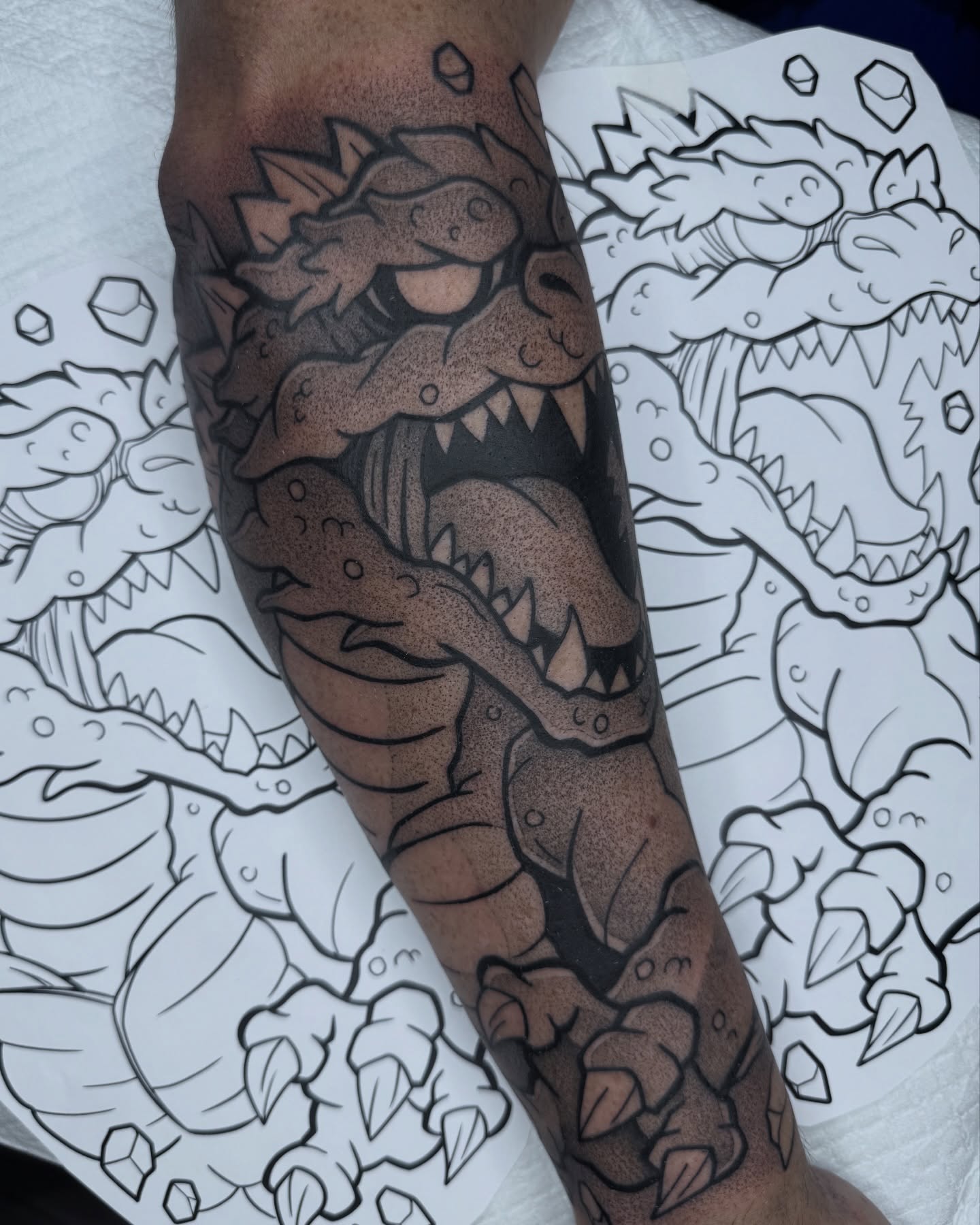 Dinosaur dotwork tattoo on the forearm by Donnie Moore