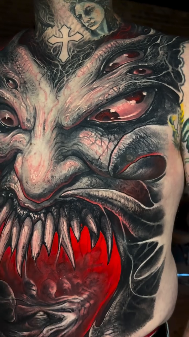Dark art tattoo on the upper arm by Brandon Herrera