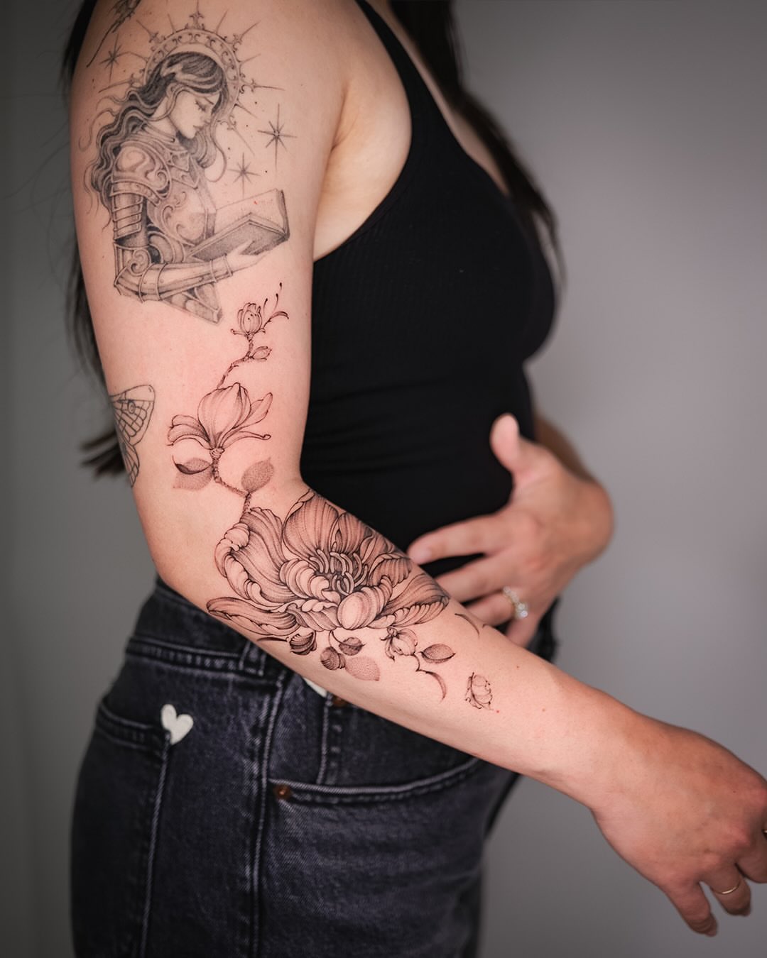 Religious figure reading book black and grey tattoo on the forearm by Esther ✣ Fine Line Floral Tattoo Artist LA, Los Angeles, California