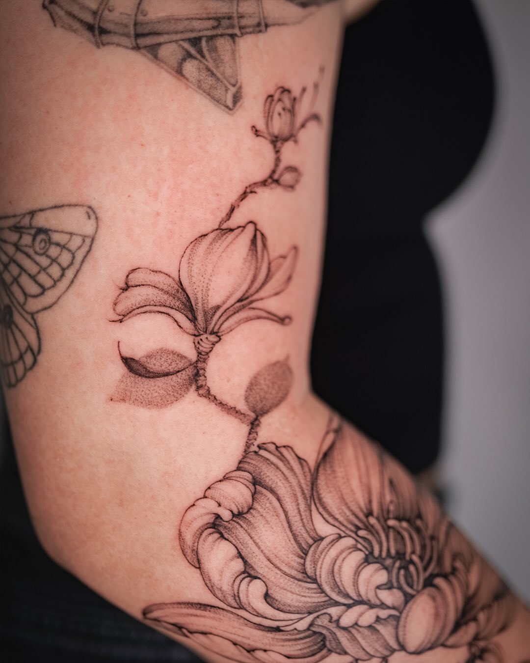 Lotus flower black and grey tattoo on the upper arm by Esther ✣ Fine Line Floral Tattoo Artist LA, Los Angeles, California