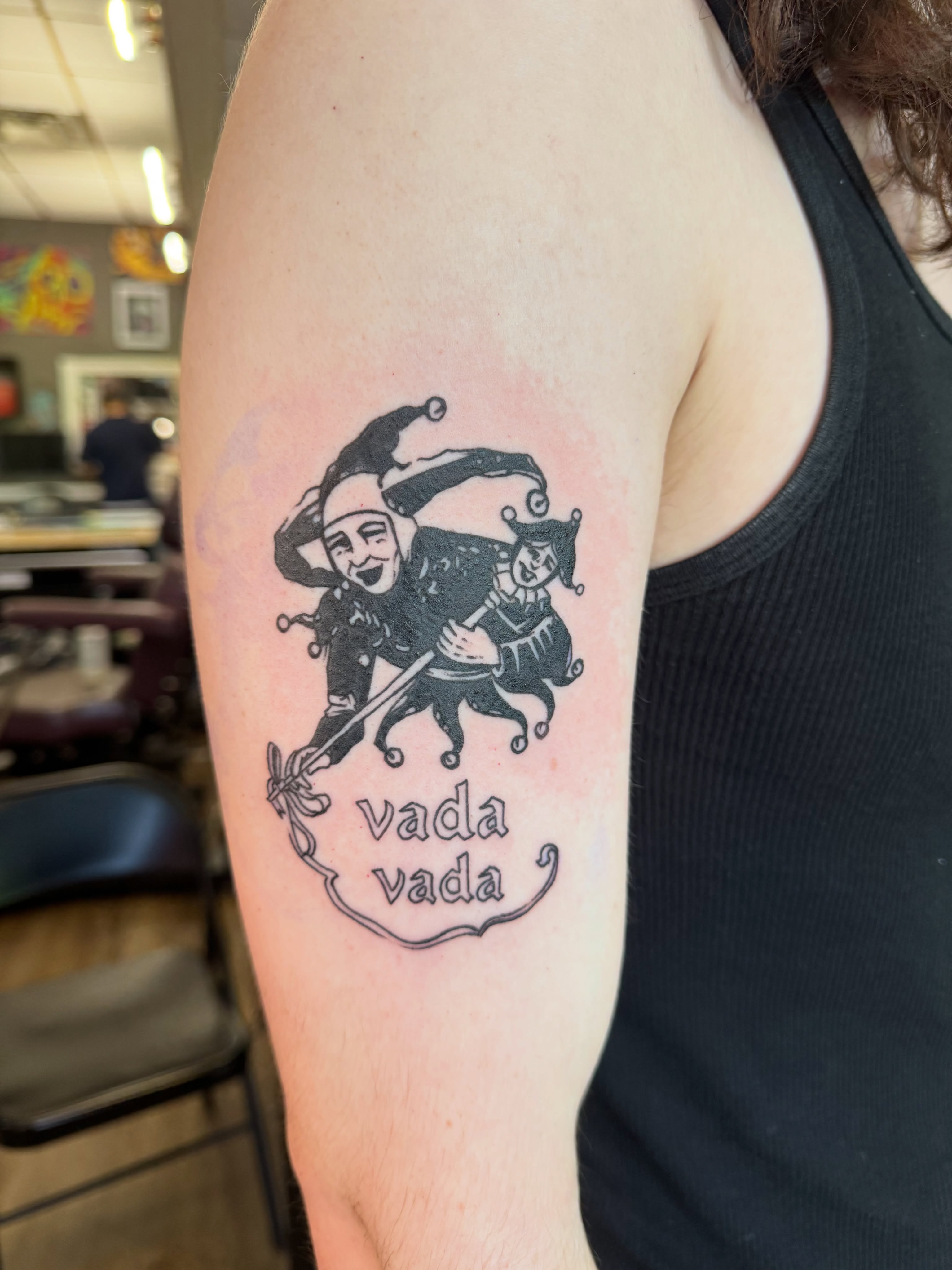 Jester and horse black and grey tattoo on the forearm by Cora Phelps