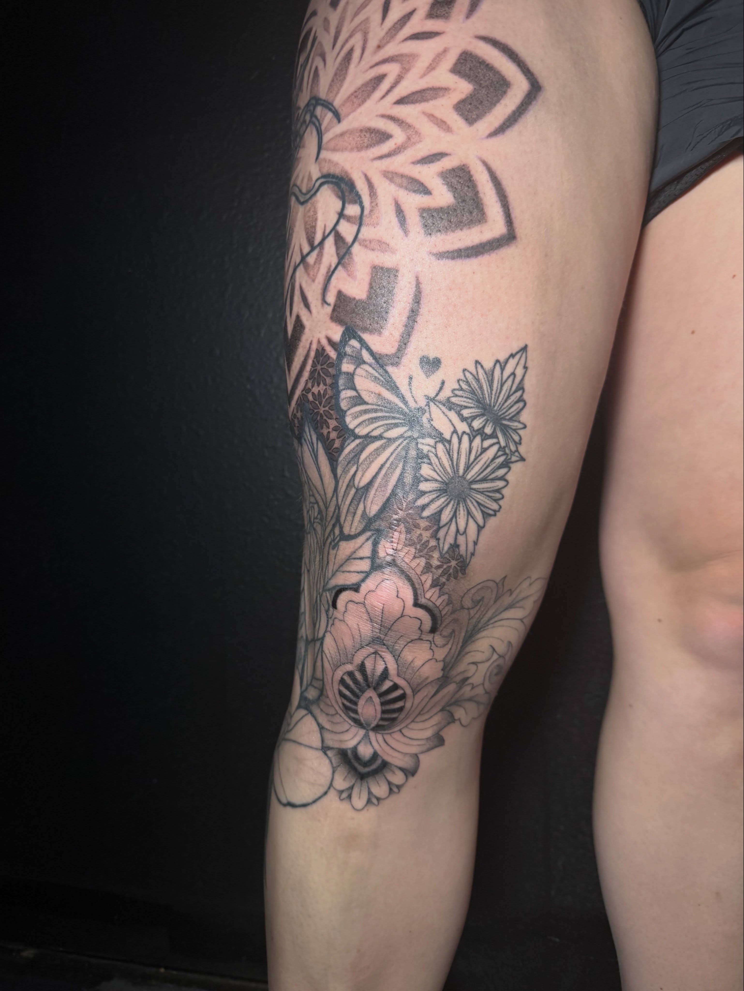Floral and butterfly black and grey tattoo on the forearm by Ink Darling, Carlisle, Iowa