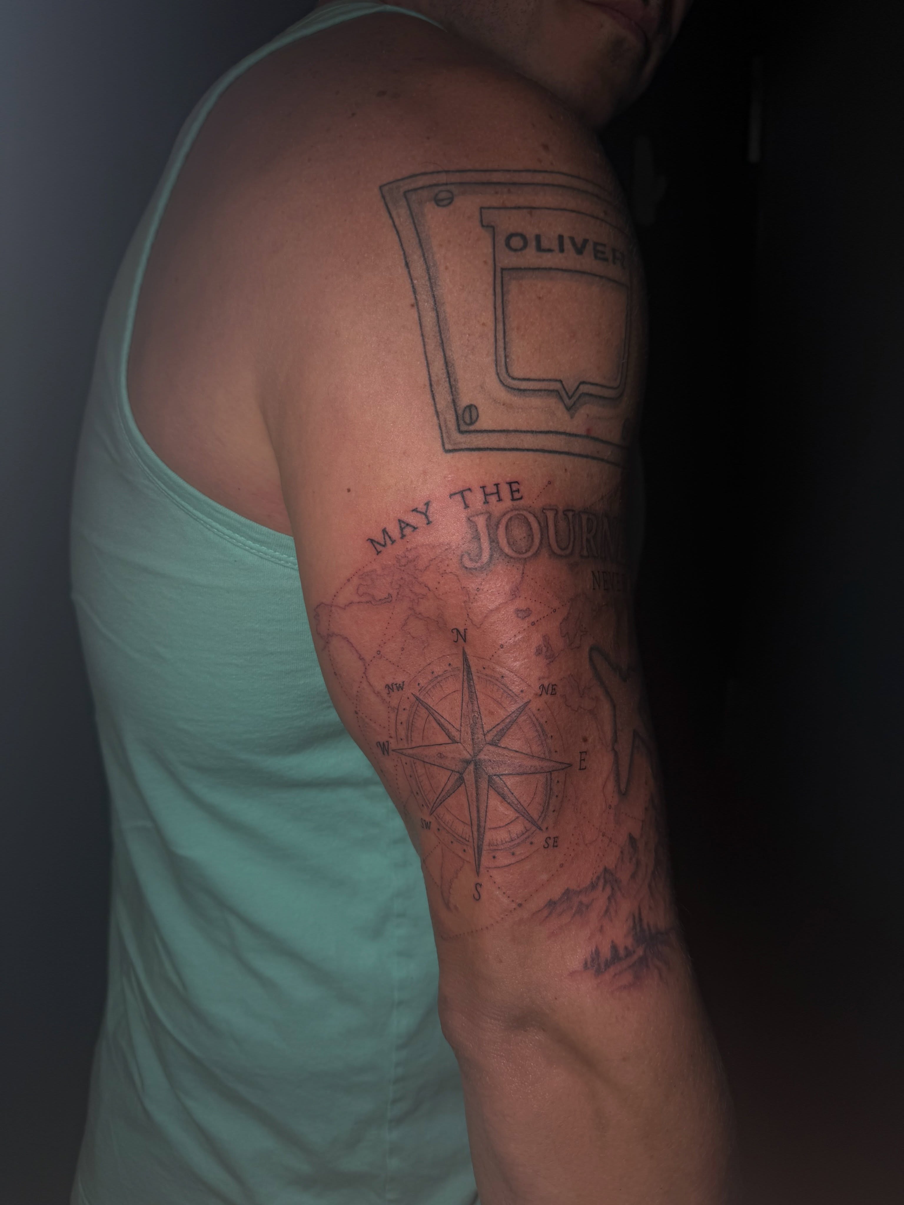 Compass and map geometric tattoo on the upper arm by Ink Darling, Carlisle, Iowa