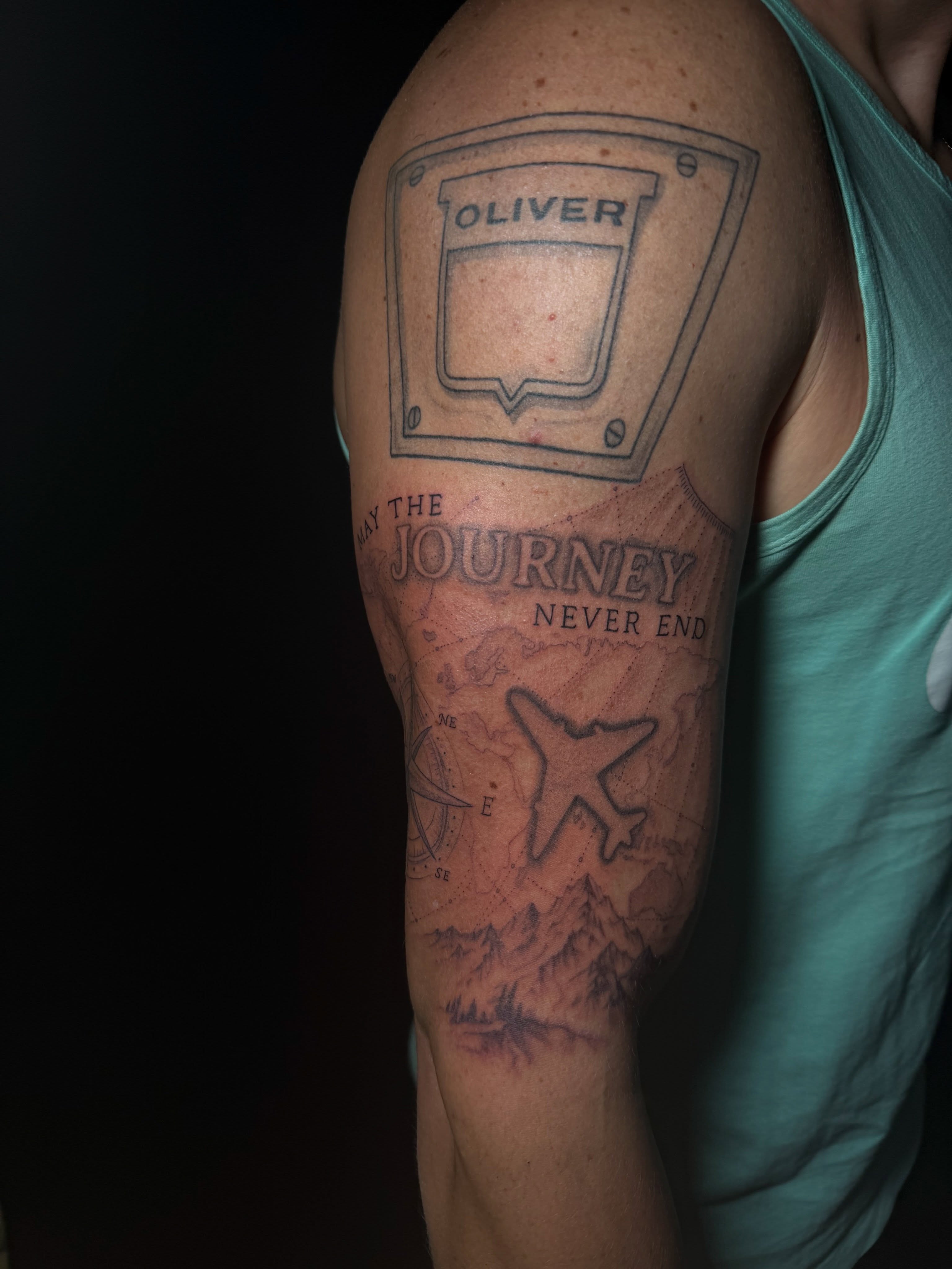 Map with airplane black and grey tattoo on the forearm by Ink Darling, Carlisle, Iowa
