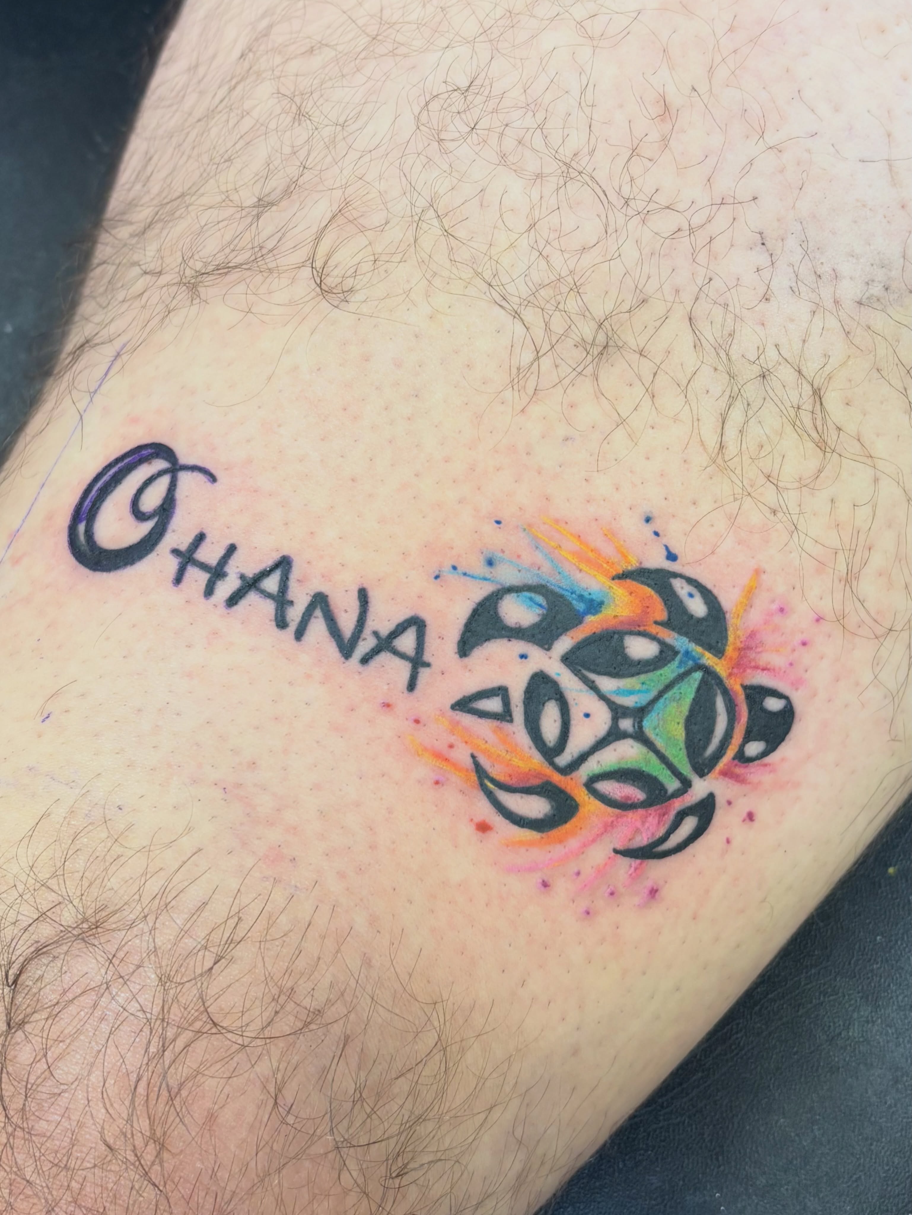 Ohana watercolor tattoo on the forearm by Thom Johns-Green
