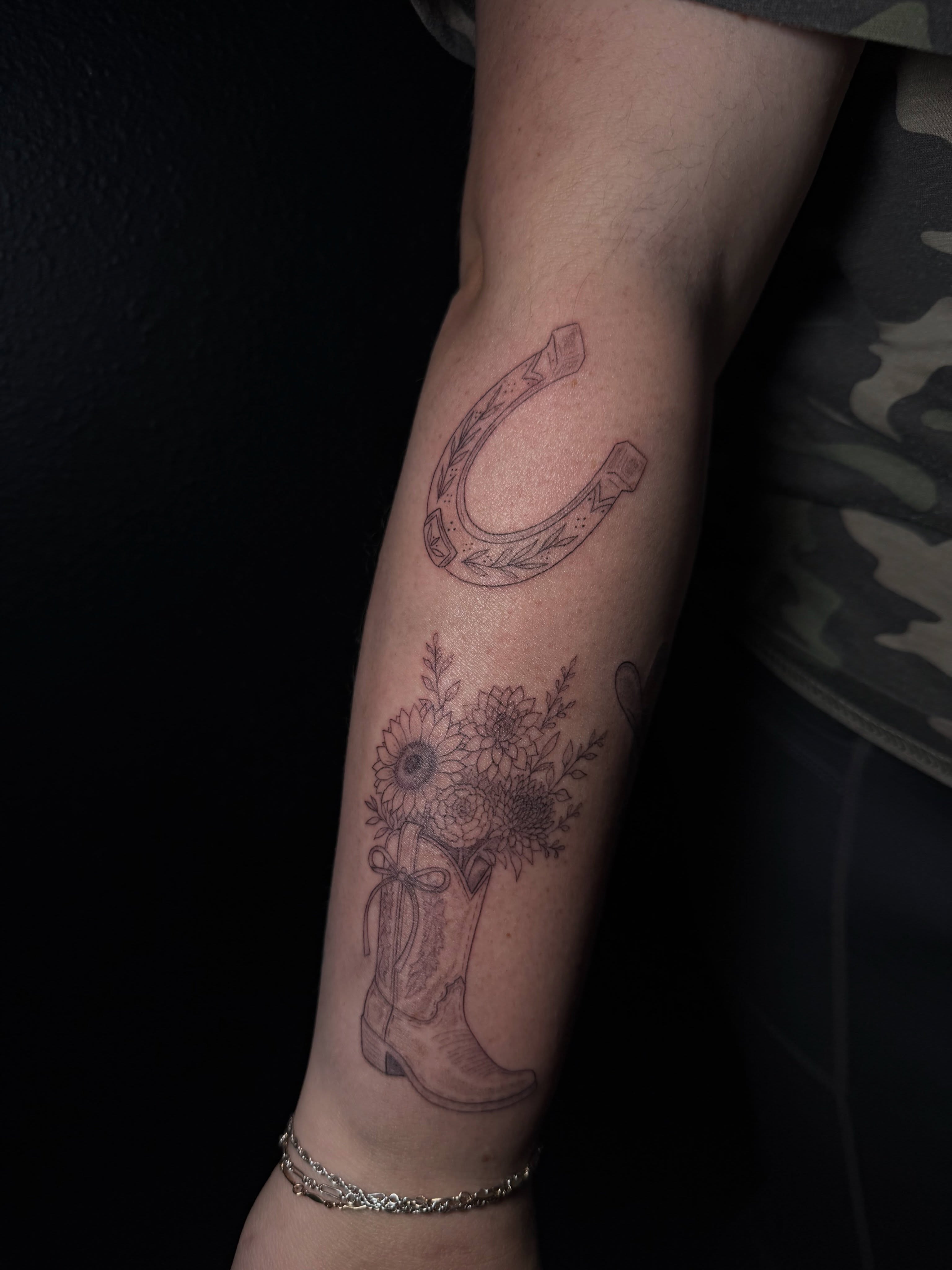 Cowboy boot bouquet black and grey tattoo on the forearm by Ink Darling, Carlisle, Iowa