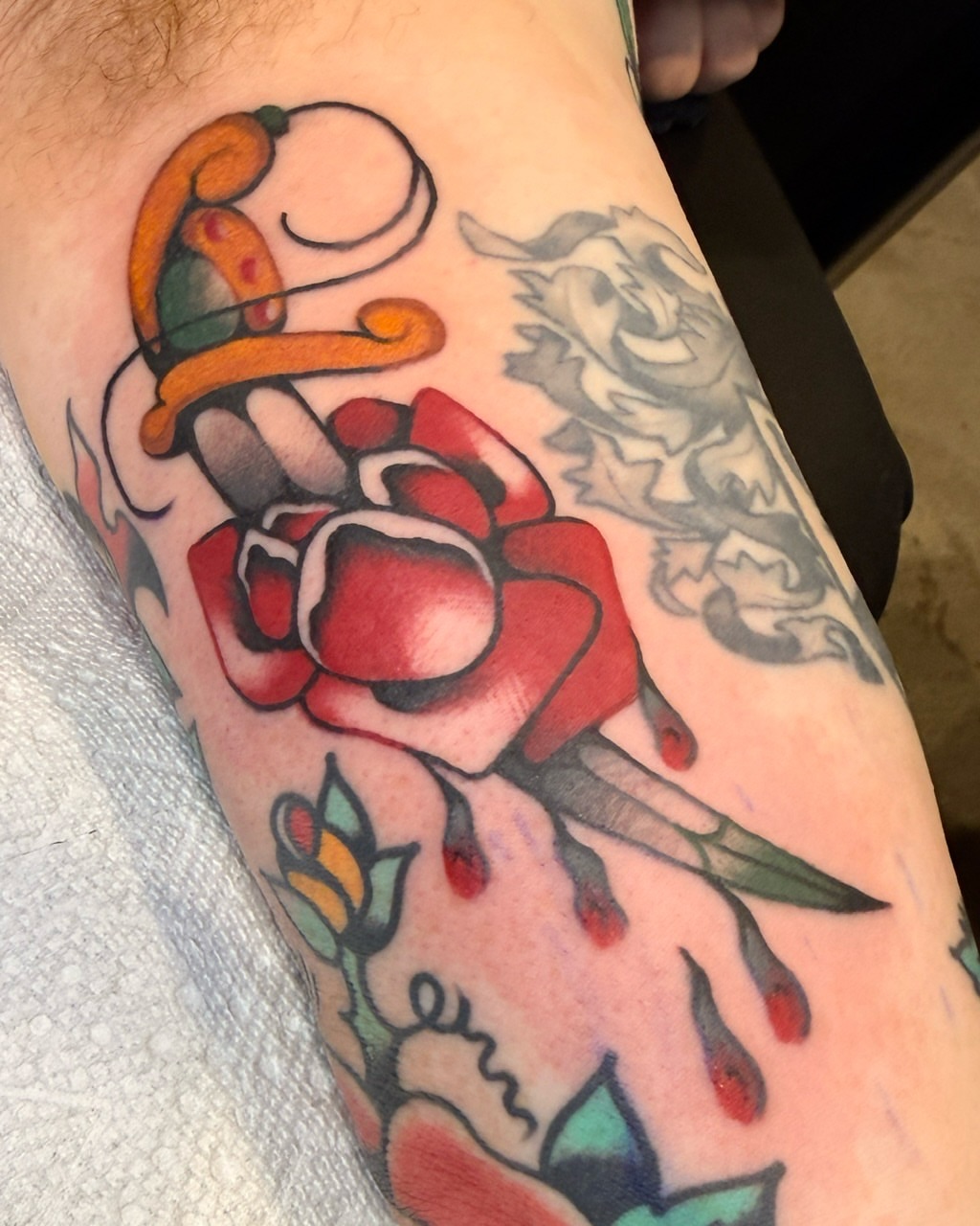 Rose and dagger American traditional tattoo on the forearm by Penny D Tattoos