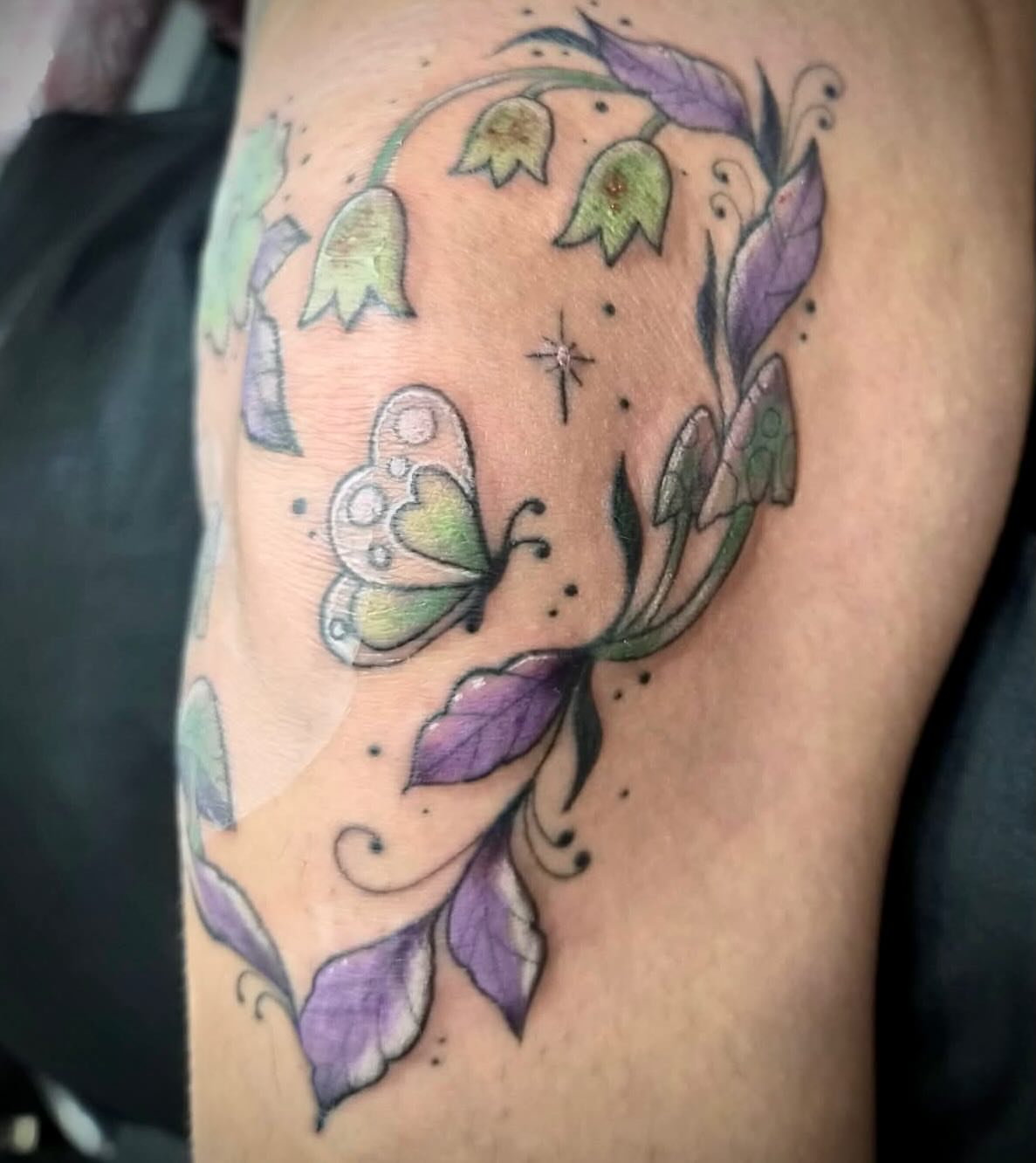 Bell flowers and butterfly dotwork tattoo on the shoulder by Freya Petersen