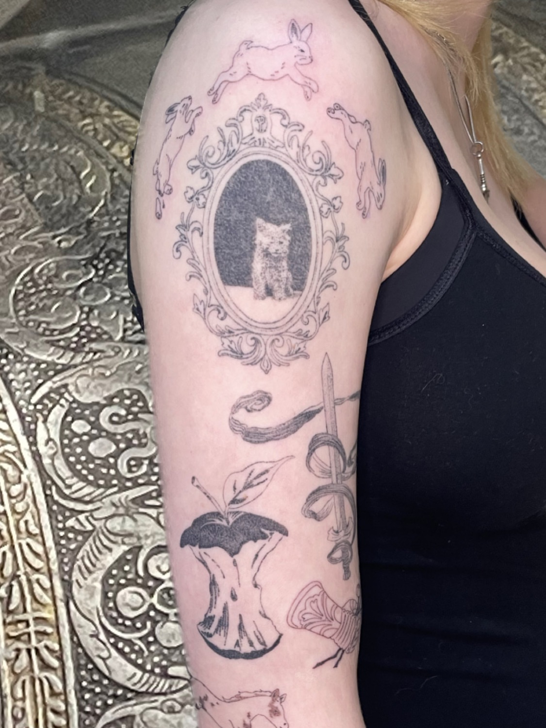 Cat portrait black and grey tattoo on the forearm by cait