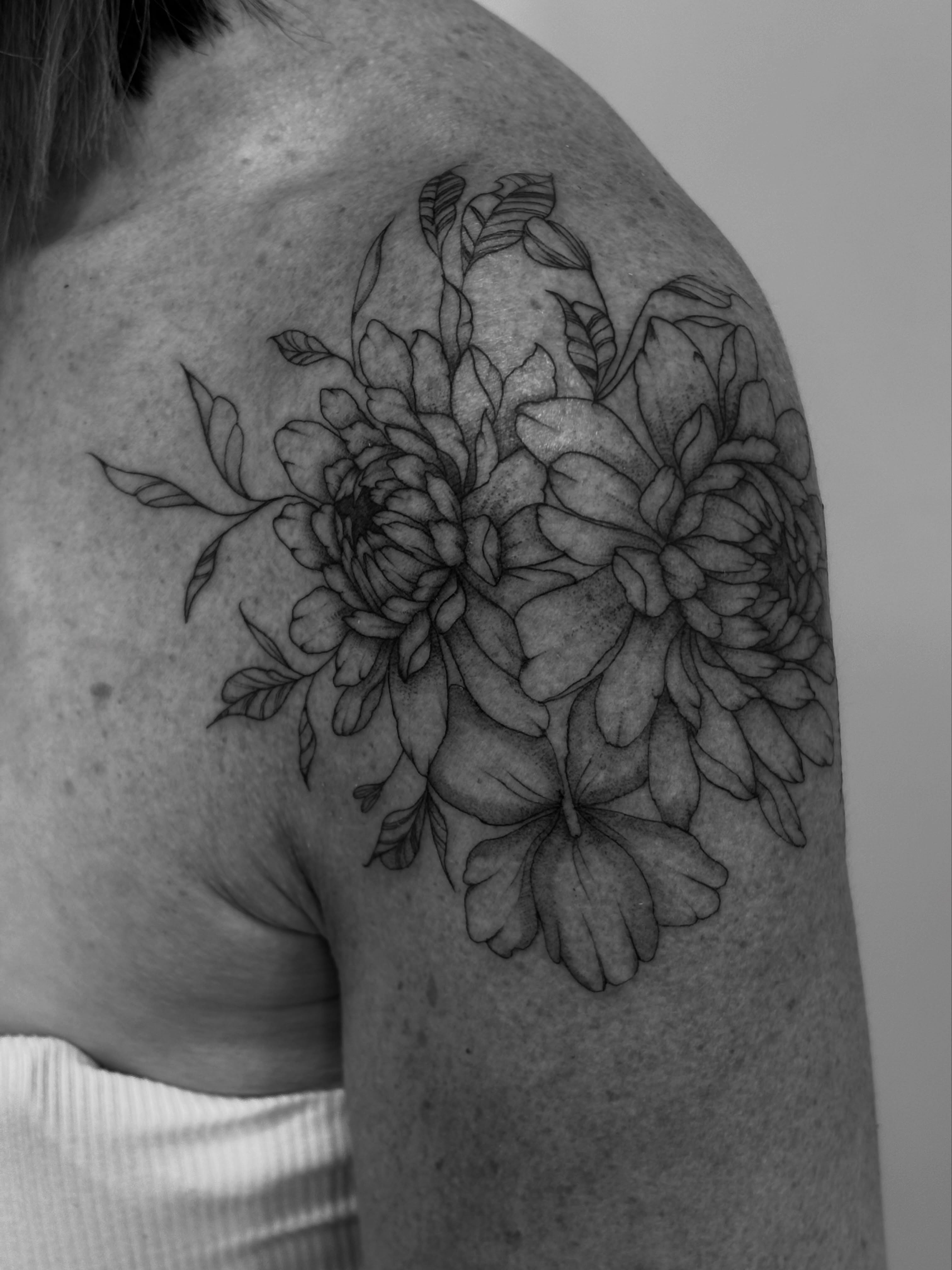 Chrysanthemums black and grey tattoo on the shoulder by Tayler, Tooele, Utah