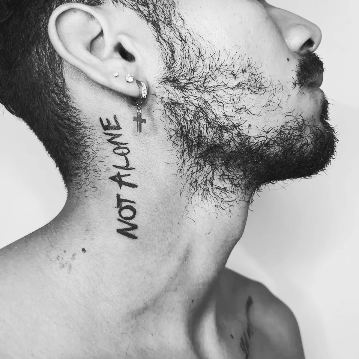 Not alone lettering script tattoo on the neck by Miami Beach Tattoo Artist