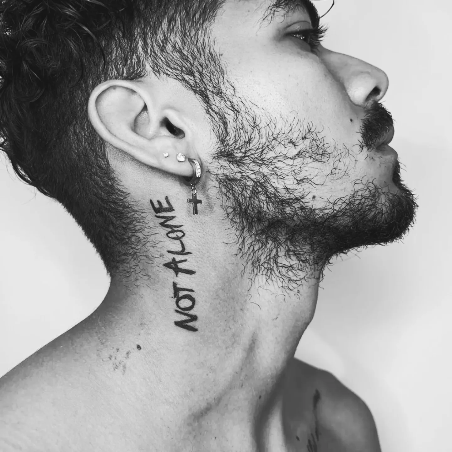 Not alone lettering script tattoo on the neck by Miami Beach Tattoo Artist