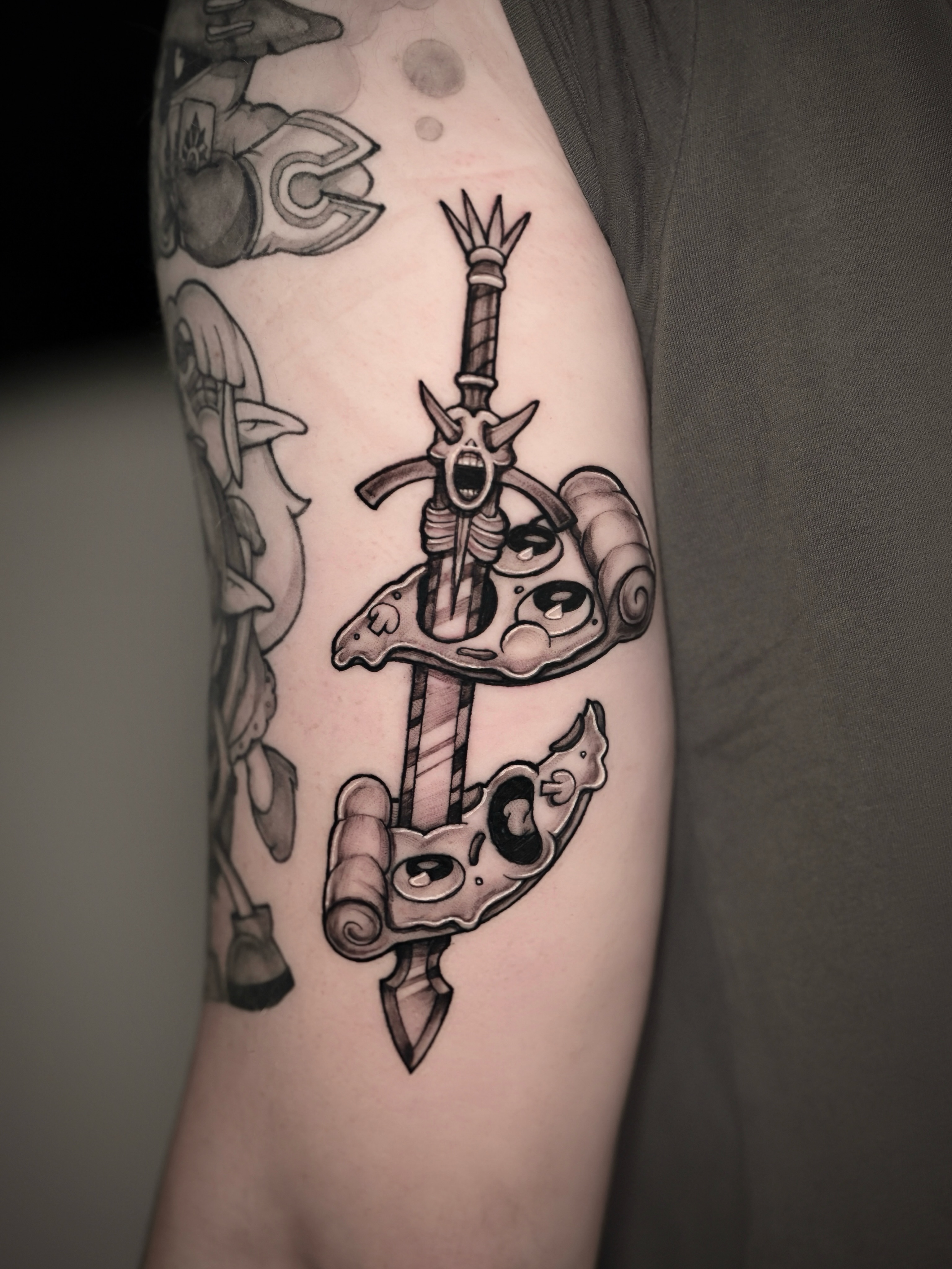 Sword and ram skull realism tattoo on the forearm by Zonghuan Wu