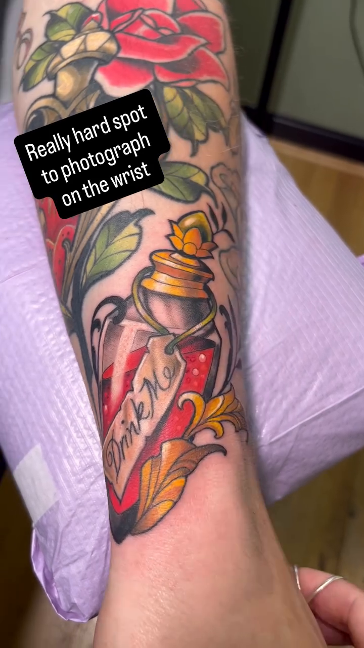 Poison bottle with roses American traditional tattoo on the forearm by Megan Merrell (Butler)