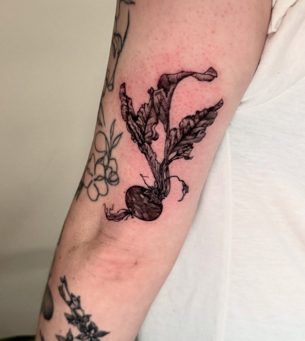 Root vegetable black and grey tattoo on the forearm by C.J. Pennington