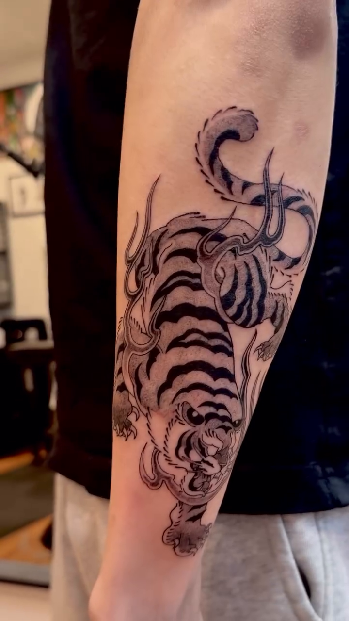 Tiger and octopus tattoo realism tattoo on the forearm by Hery Anwar