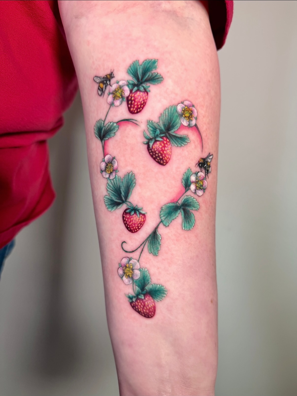 Strawberries and bees watercolor tattoo on the forearm by aria, Austin, Texas