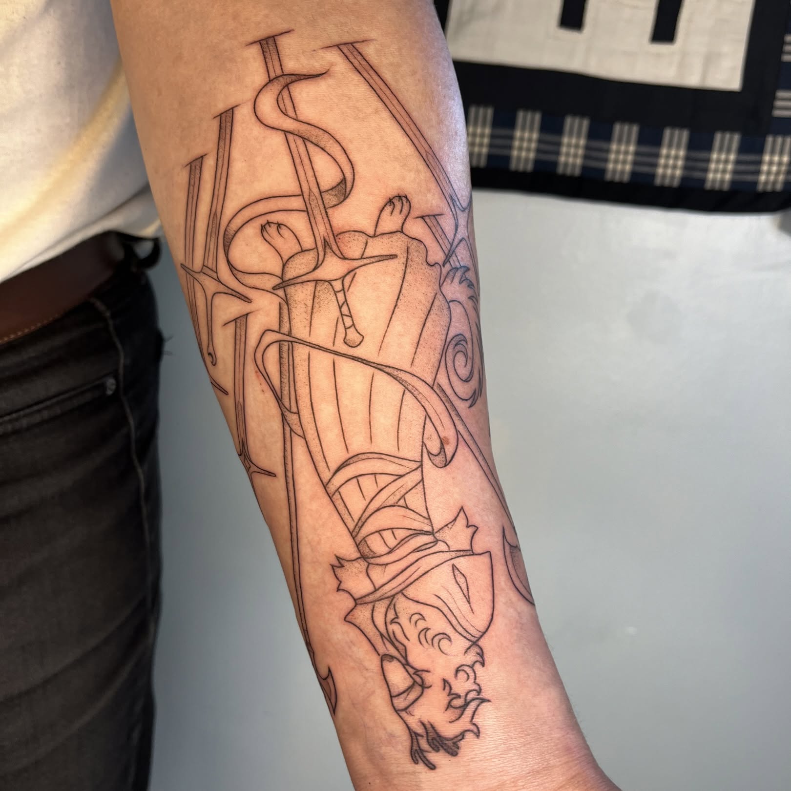 Dragon and knight black and grey tattoo on the forearm by Iggy Montgomery (they