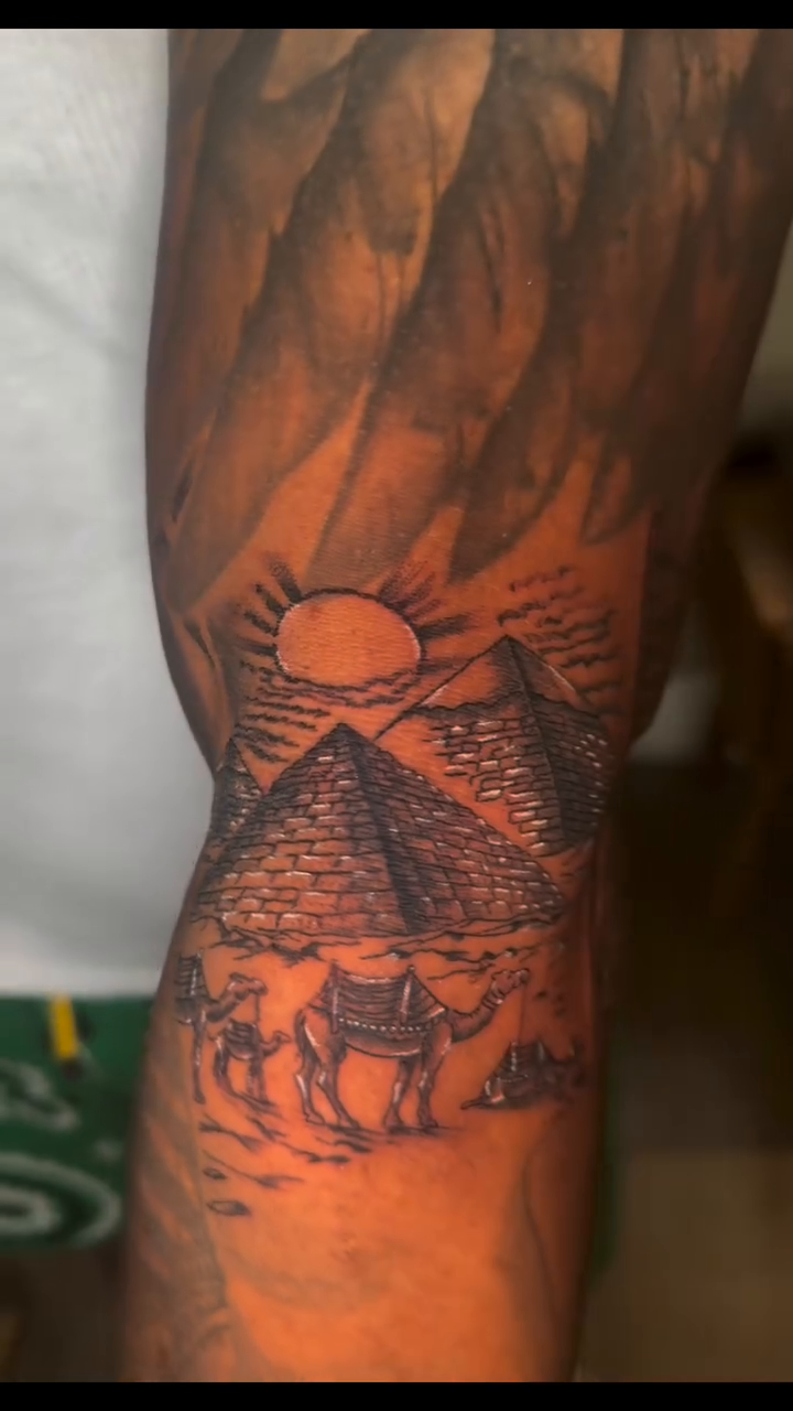 Egyptian pyramids and camels surrealism tattoo on the forearm by InkedByJide Tattoo, Atlanta, Georgia