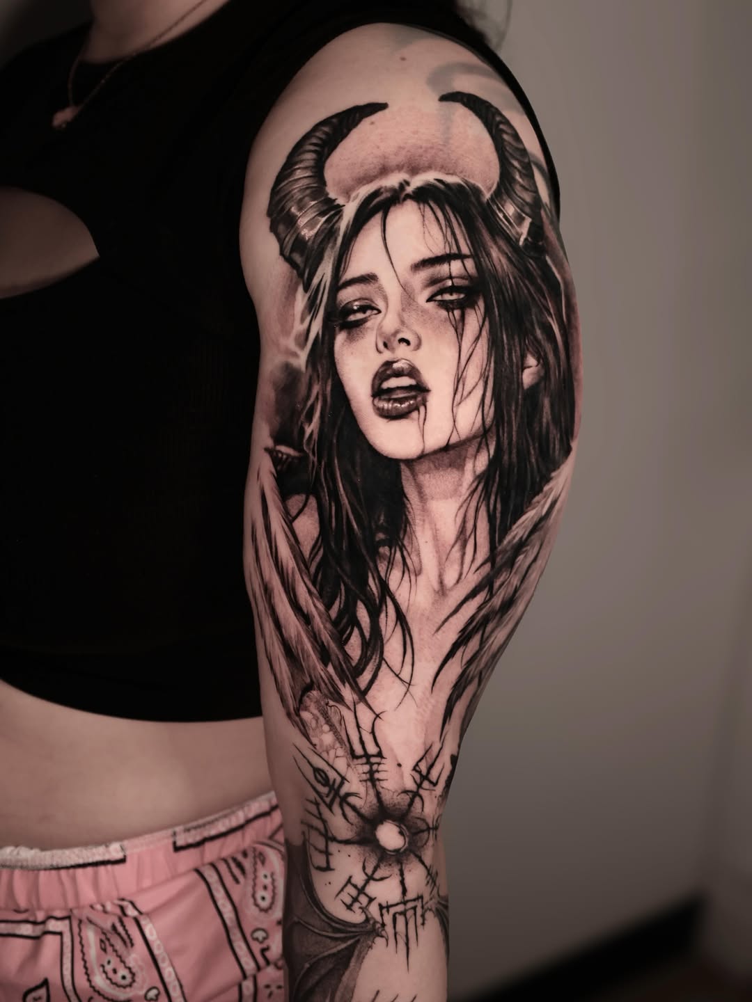 Demon woman with horns and wings realism tattoo on the upper arm by Anna Chernova, San Francisco, California