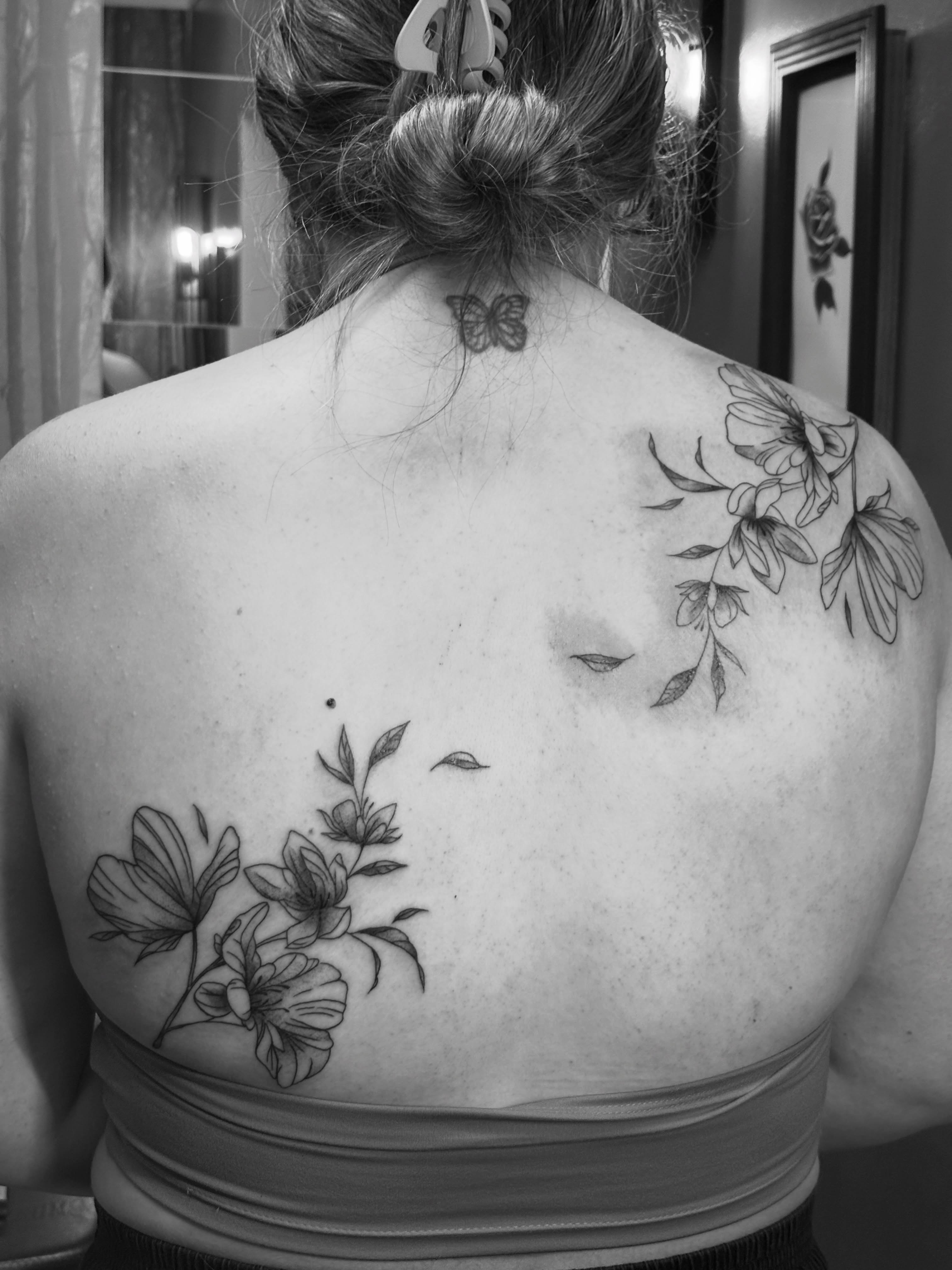 Flowers and butterfly black and grey tattoo on the back by ⋆.˚ ☾ .⭒˚ alaina