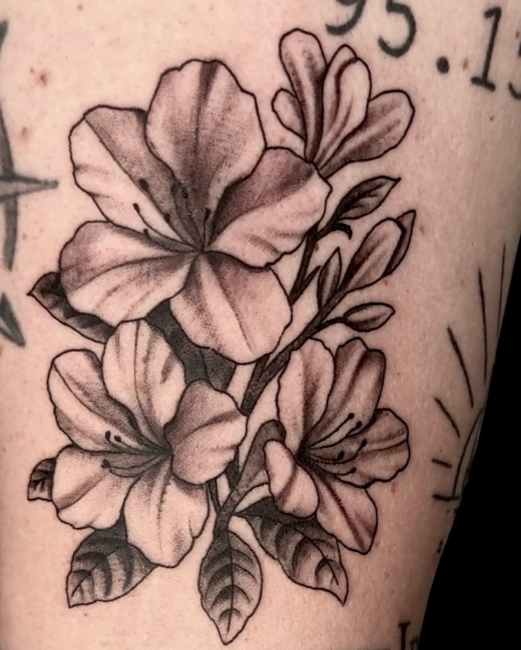 Flowers black and grey tattoo on the forearm by Cody Glenn