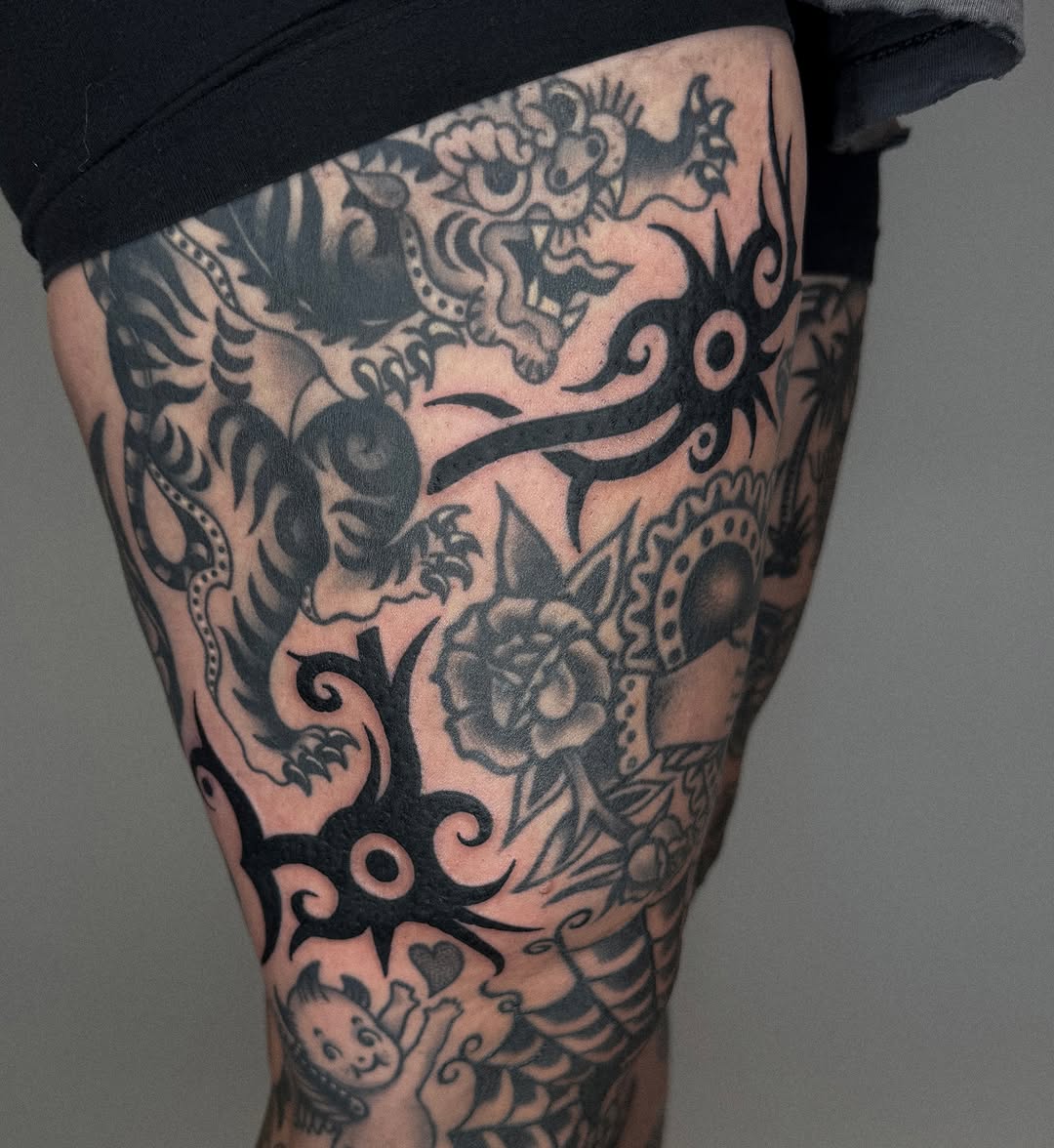 Dragon and rose tribal tattoo on the thigh by nicky joe