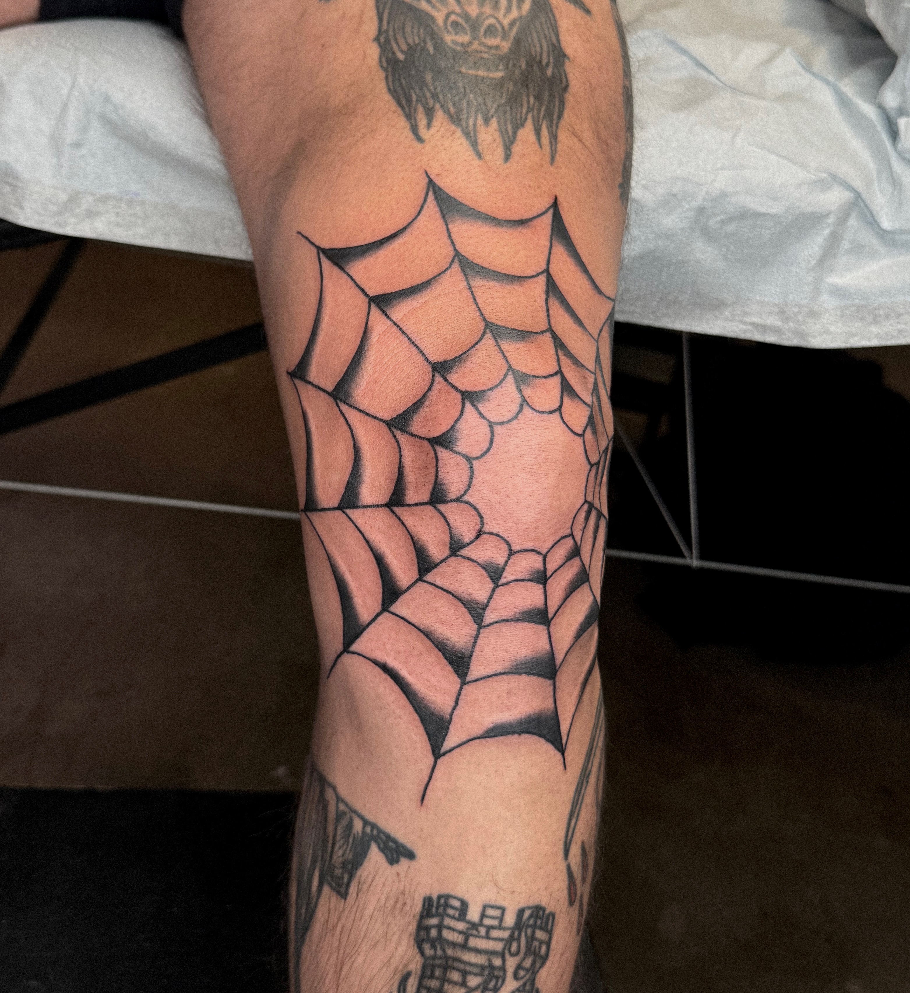 Spider web geometric tattoo on the forearm by nicky joe