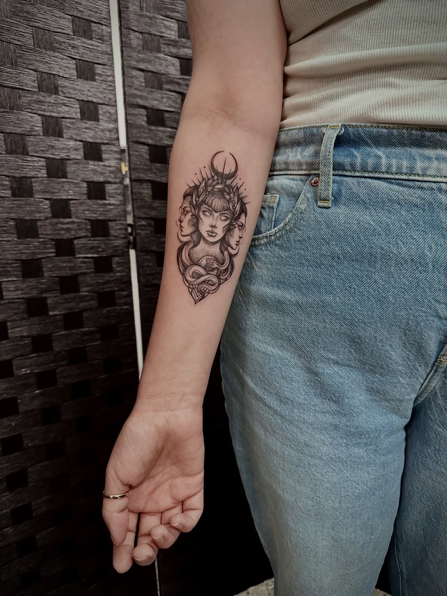 Woman with snake black and grey tattoo on the forearm by Marlyn “Lala”