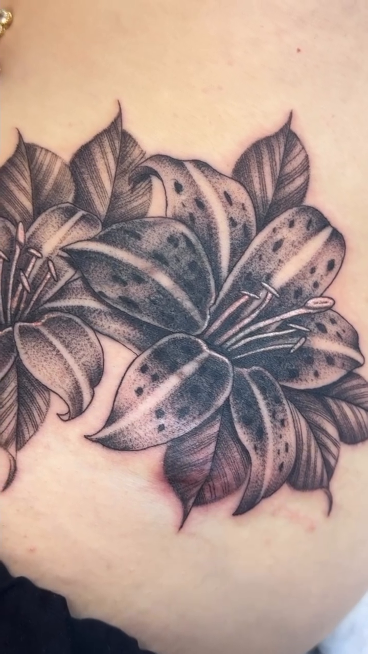 Lilies realism tattoo by @nudylicioustattoos