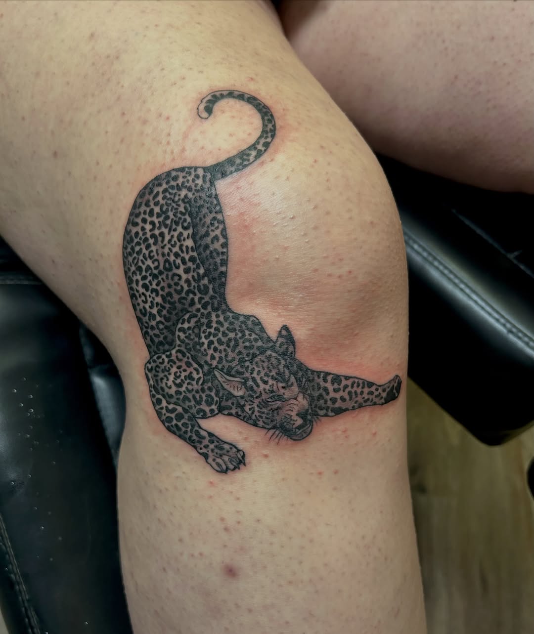 Leopard black and grey tattoo on the thigh by Jamie Winn