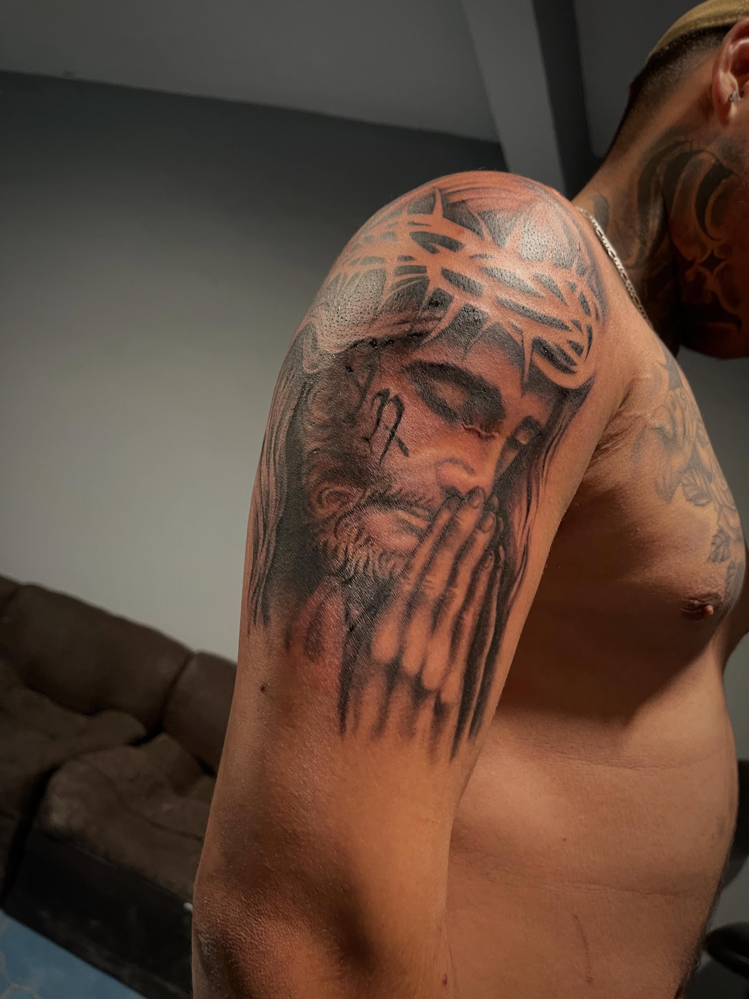 Praying hands realism tattoo on the shoulder by Tu SanchoTattoos