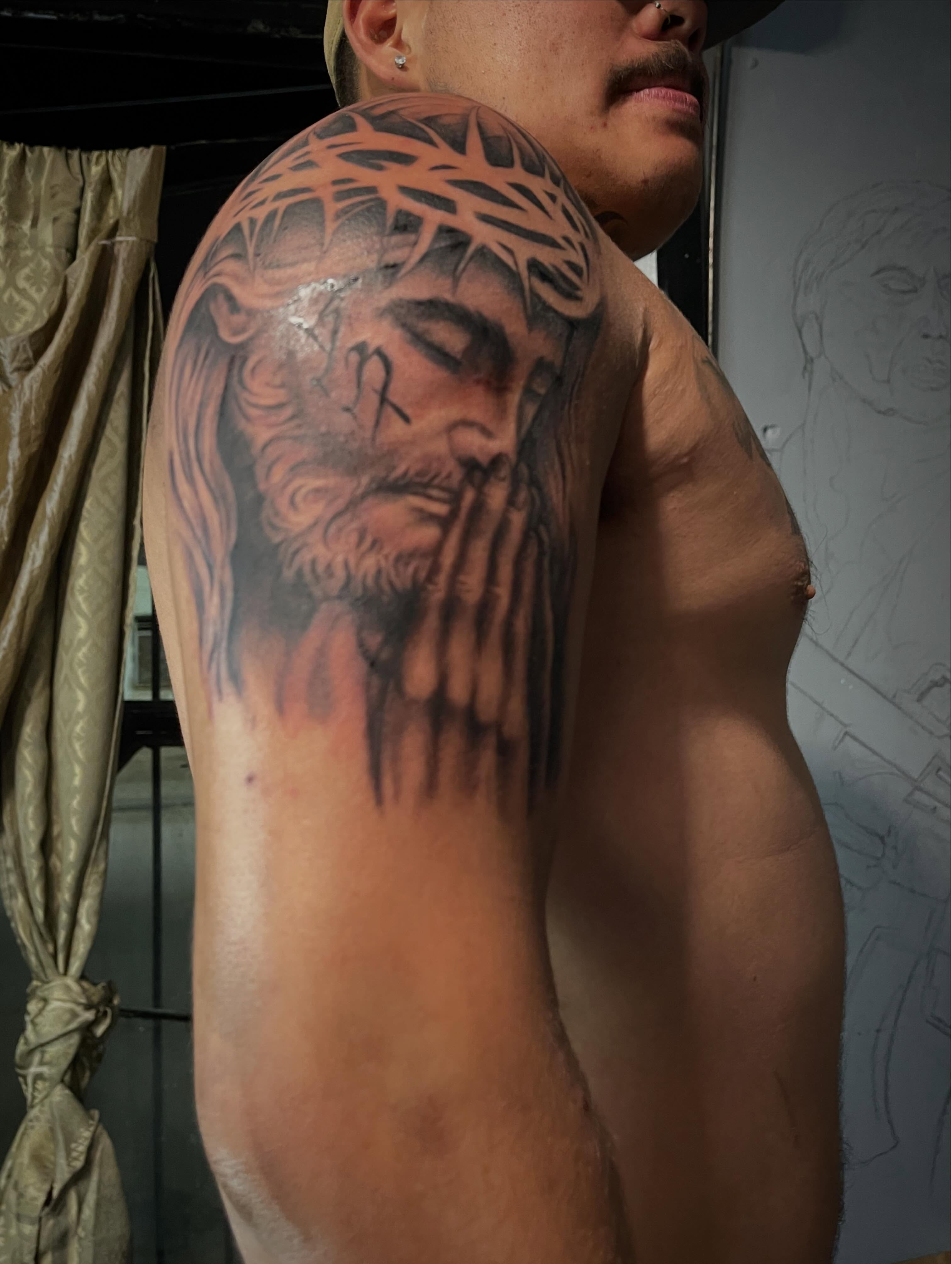 Religious figure realism tattoo on the shoulder by Tu SanchoTattoos