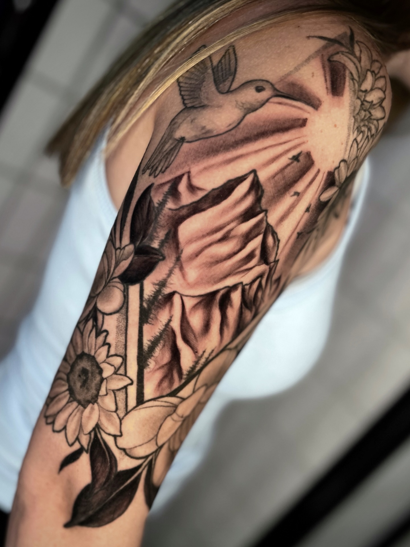 Bird and sunflower black and grey tattoo on the forearm by πΈππππππ π½ππππππππ