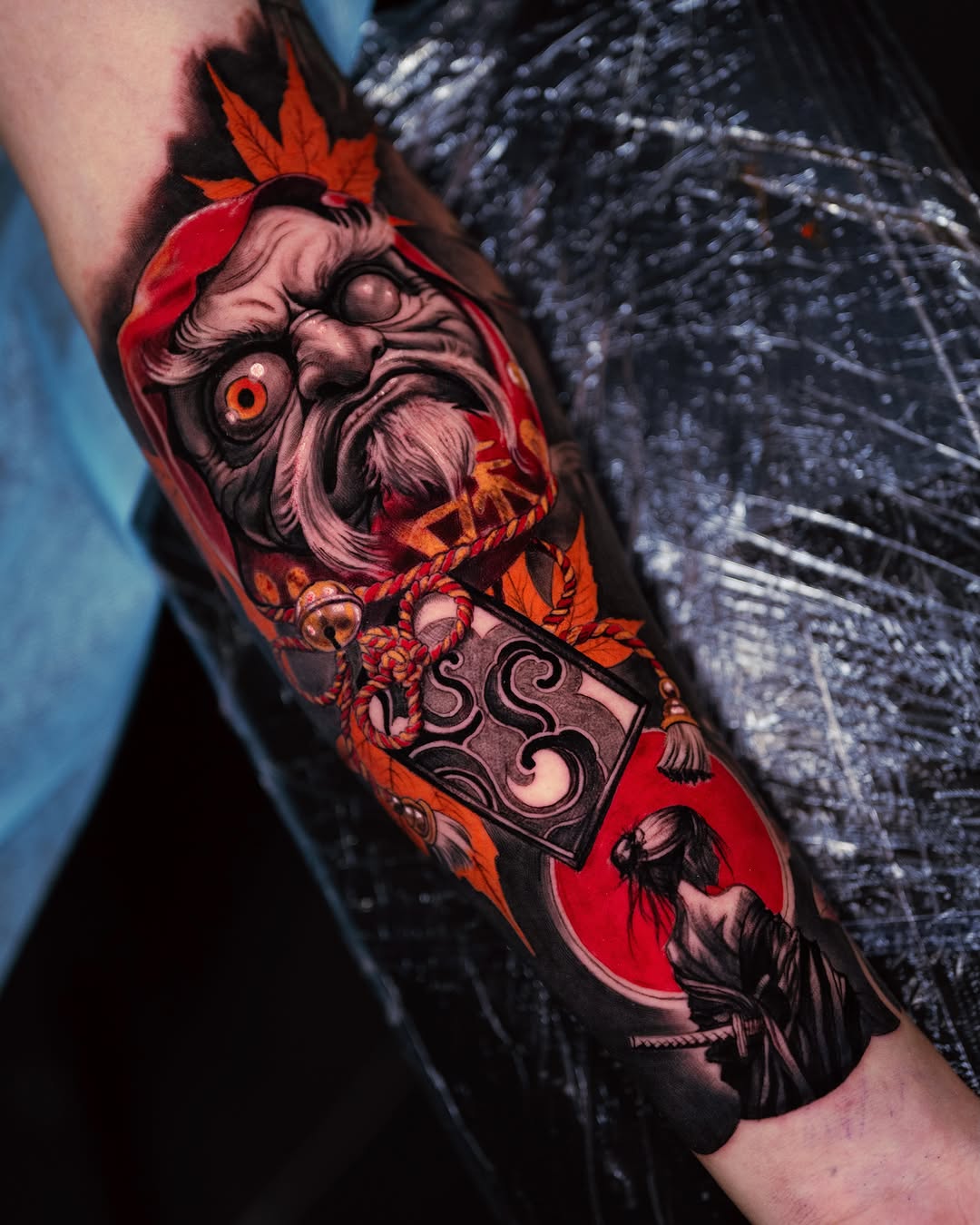 Daruma doll and geisha Japanese tattoo on the forearm by Marcos Salamanca