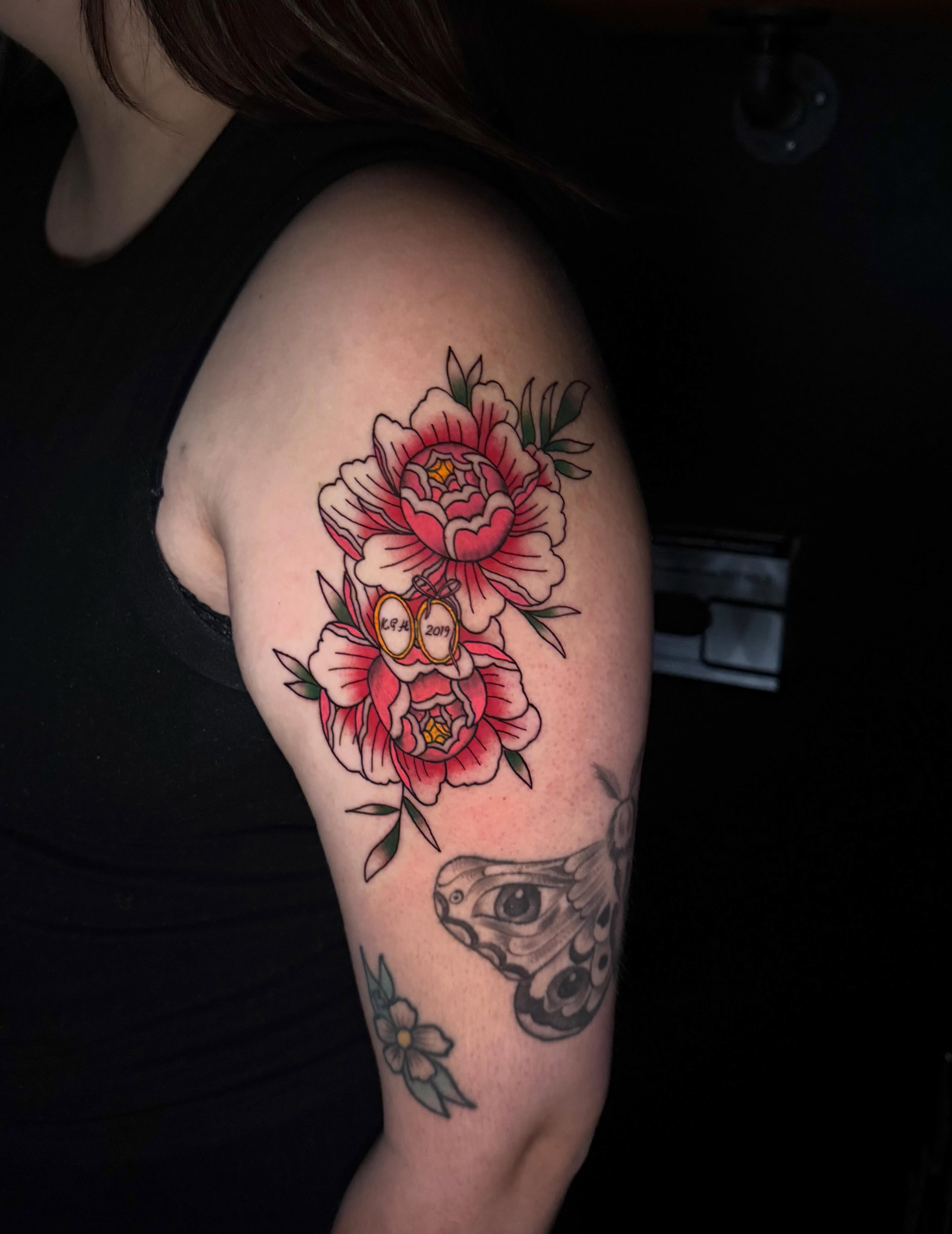 Peony and frog American traditional tattoo on the upper arm by Delaney Cooper