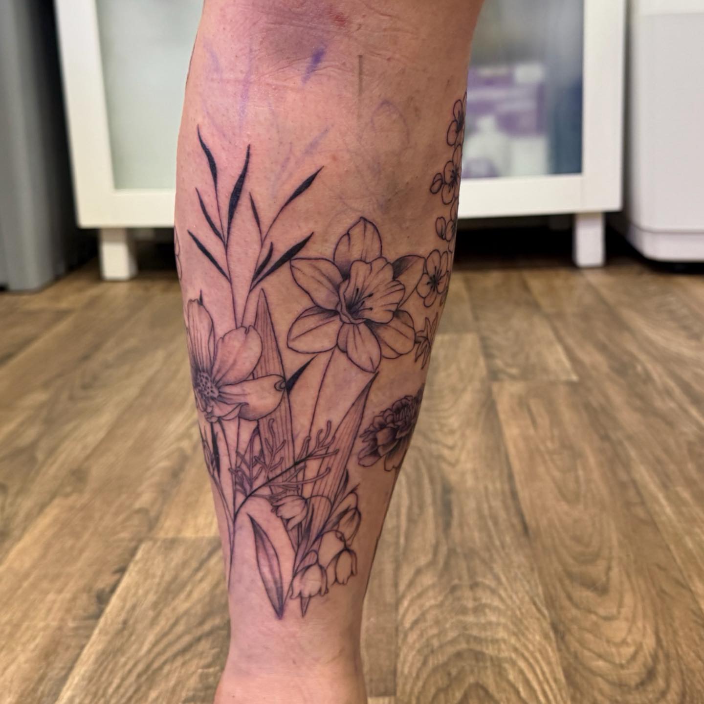 Floral bouquet black and grey tattoo on the calf by PxINK, Crystal, Minnesota