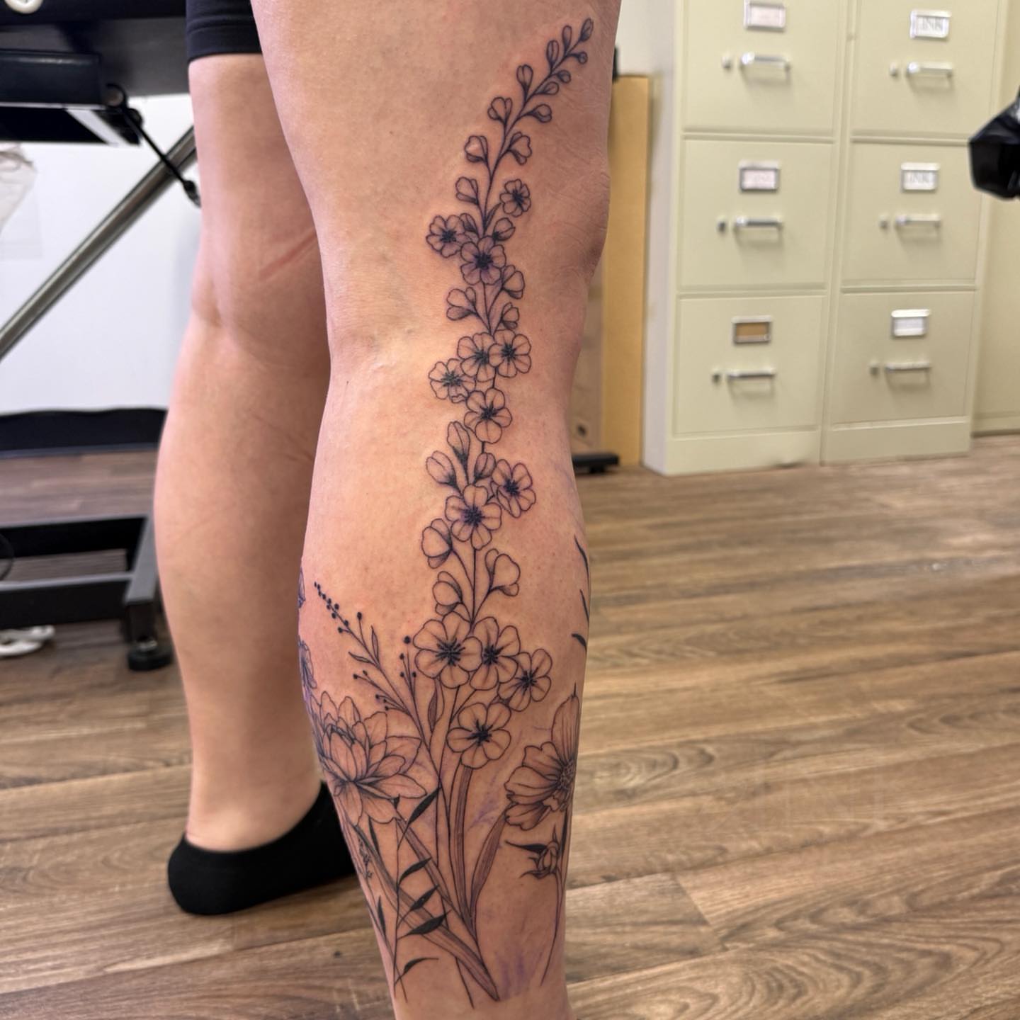 Floral arrangement black and grey tattoo on the calf by PxINK, Crystal, Minnesota
