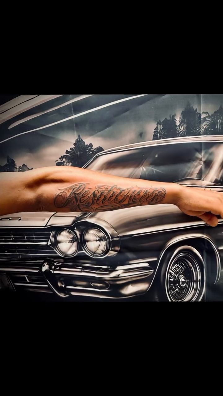 Chicano tattoo on the upper arm by Salvador Mendoza, Sesto San Giovanni