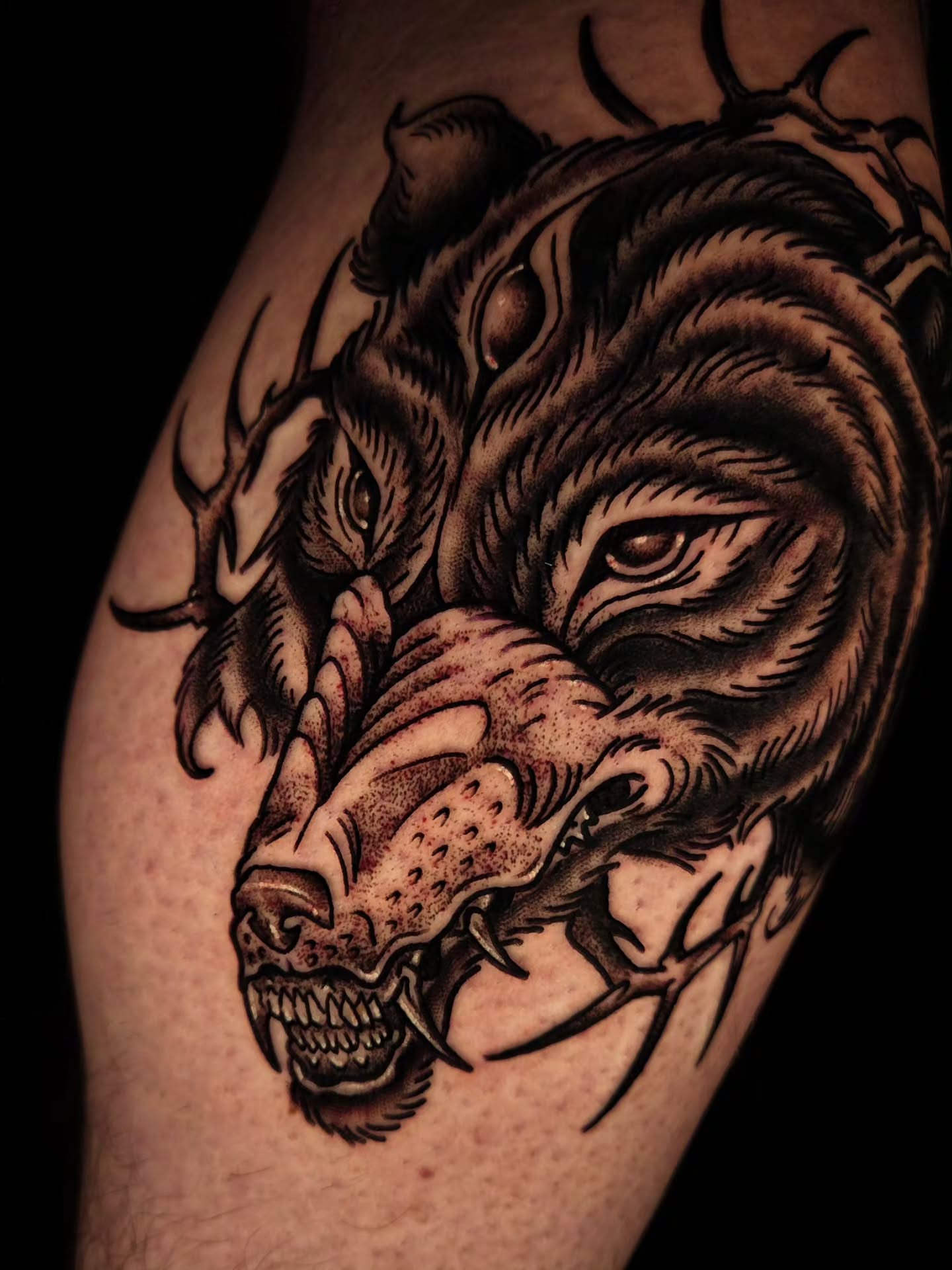 Wolf realism tattoo on the upper arm by Ian Kiser