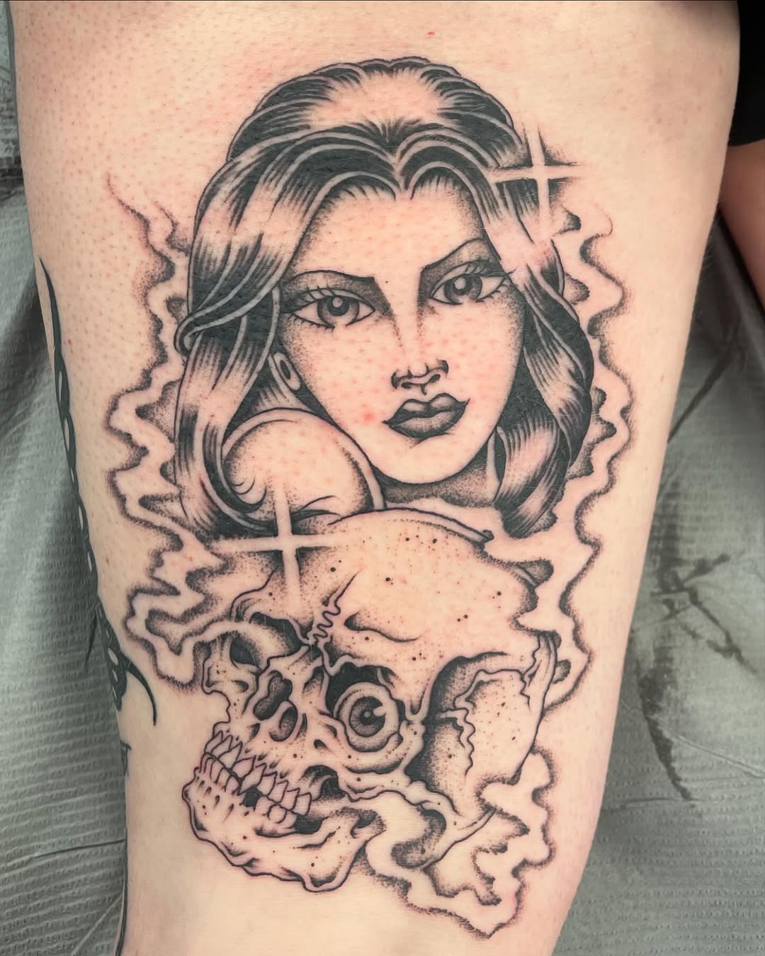 Woman and skull realism tattoo on the thigh by Brayden P Tattoo